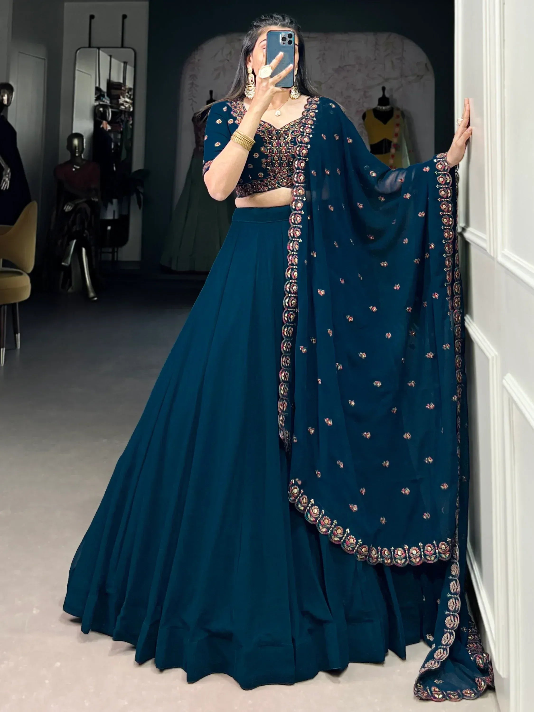 Teal blue embroidered lehenga choli with floral motifs, perfect for Indian ethnic wear events