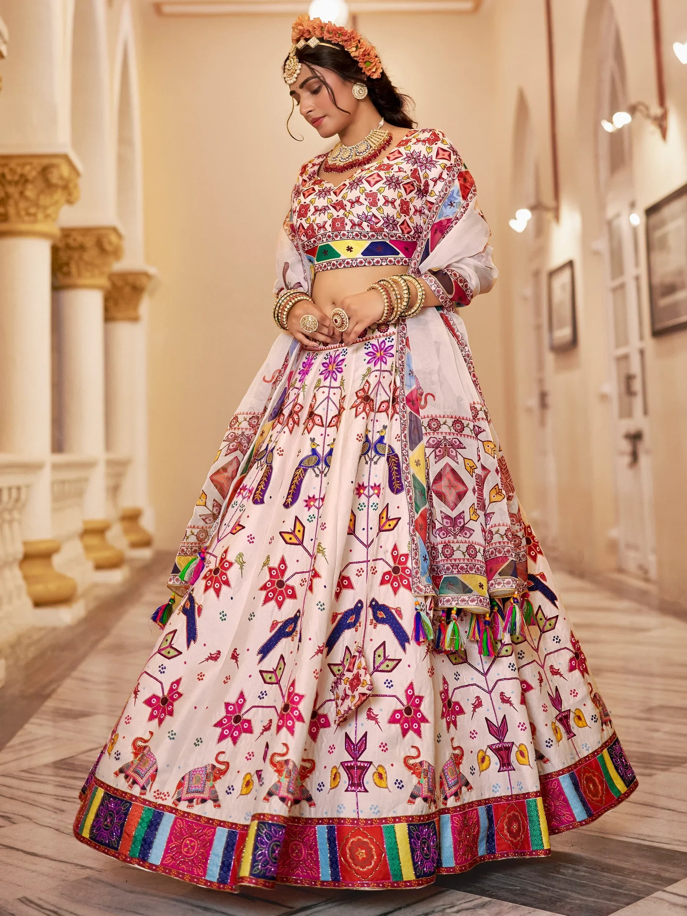 Colorful embroidered lehenga choli with floral and elephant motifs, perfect for Indian ethnic wear events.