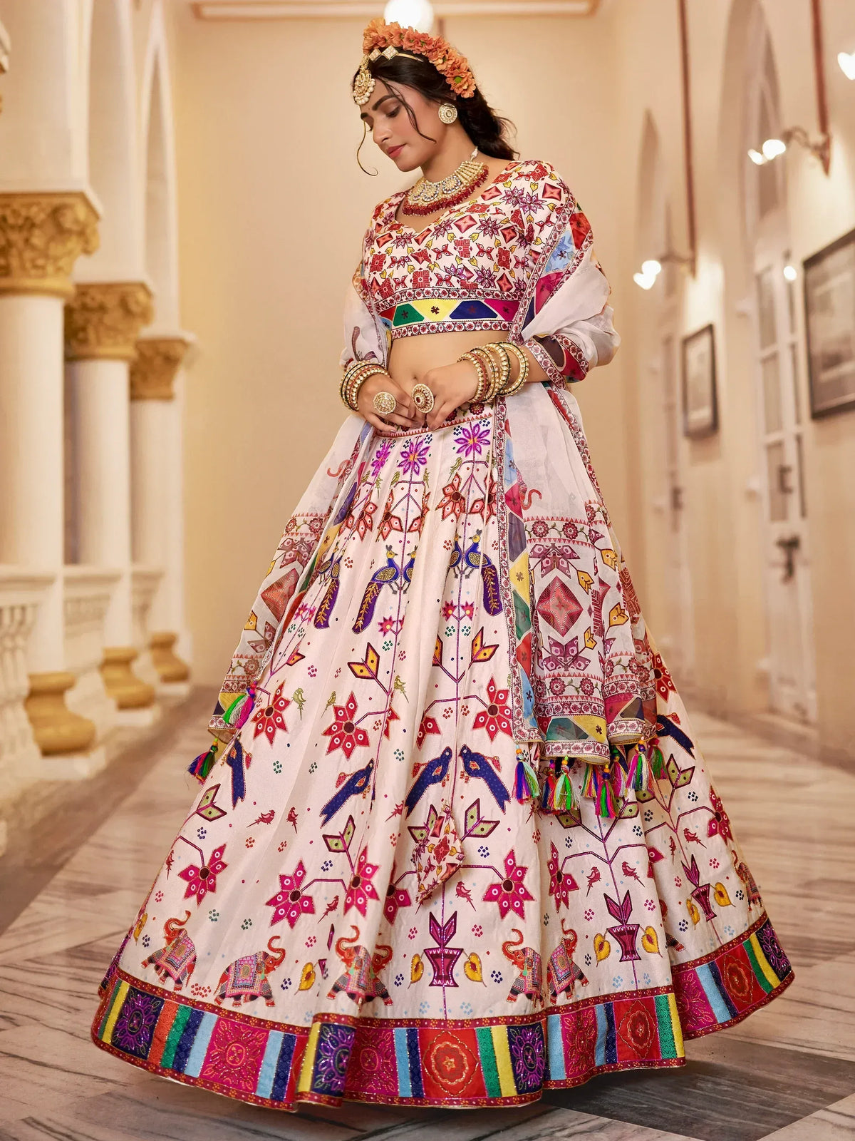 Colorful embroidered lehenga choli with floral and elephant motifs, perfect for Indian ethnic wear events.