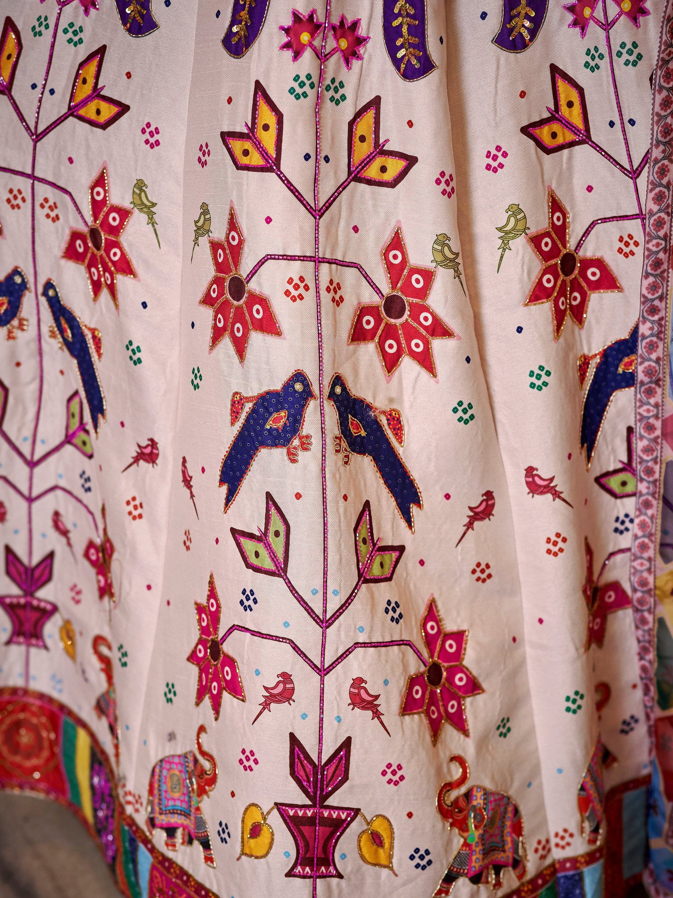 Colorful Indian ethnic wear with floral and bird embroidery, perfect for festive occasions.