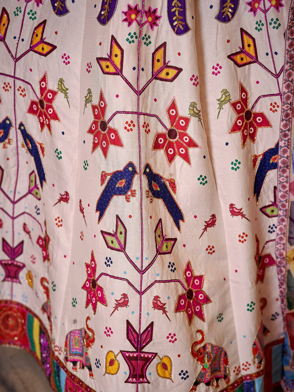 Colorful Indian ethnic wear with floral and bird embroidery, perfect for festive occasions.