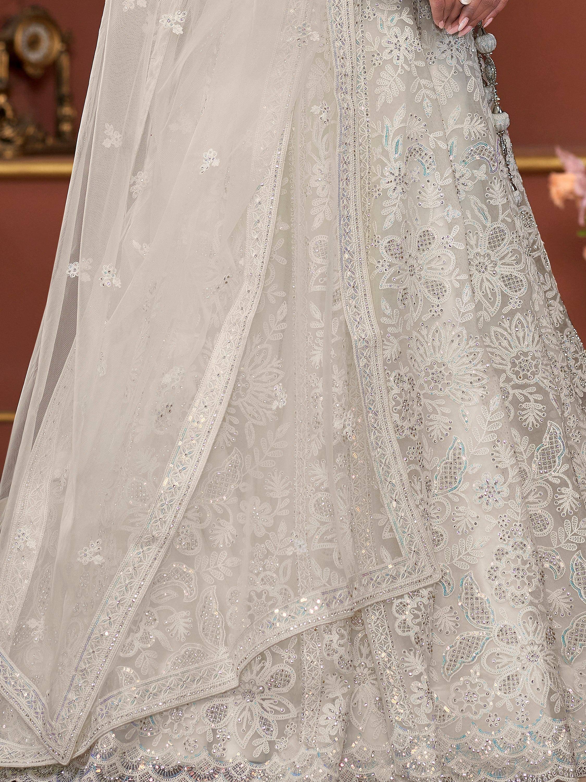 Elegant white lehenga choli with intricate floral embroidery and sequin detailing, perfect for Indian weddings.