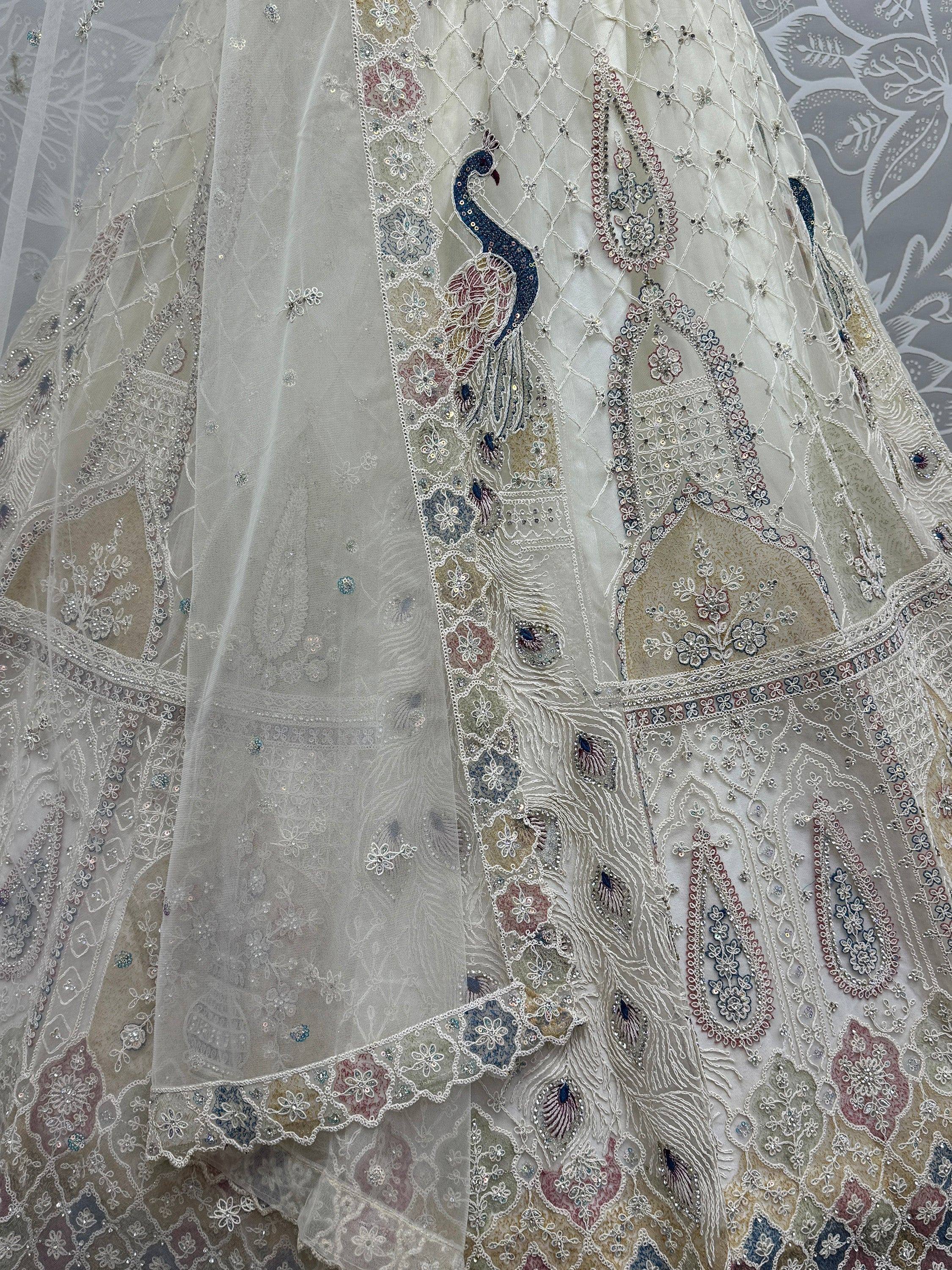 Elegant white lehenga with peacock embroidery and floral motifs, perfect for Indian weddings and festive occasions.