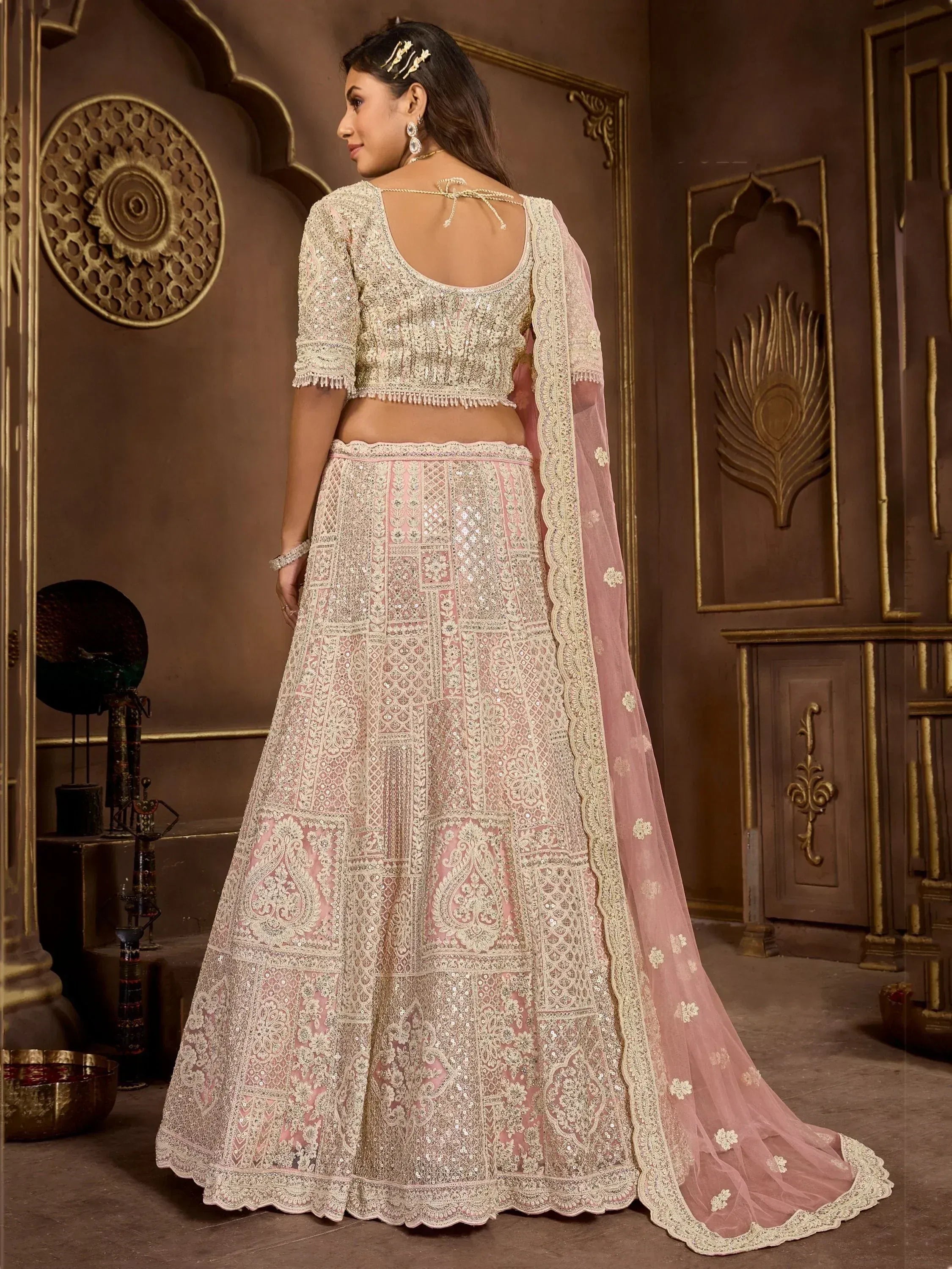 Pink and cream embroidered lehenga choli with lace dupatta, perfect for Indian weddings and festive occasions.
