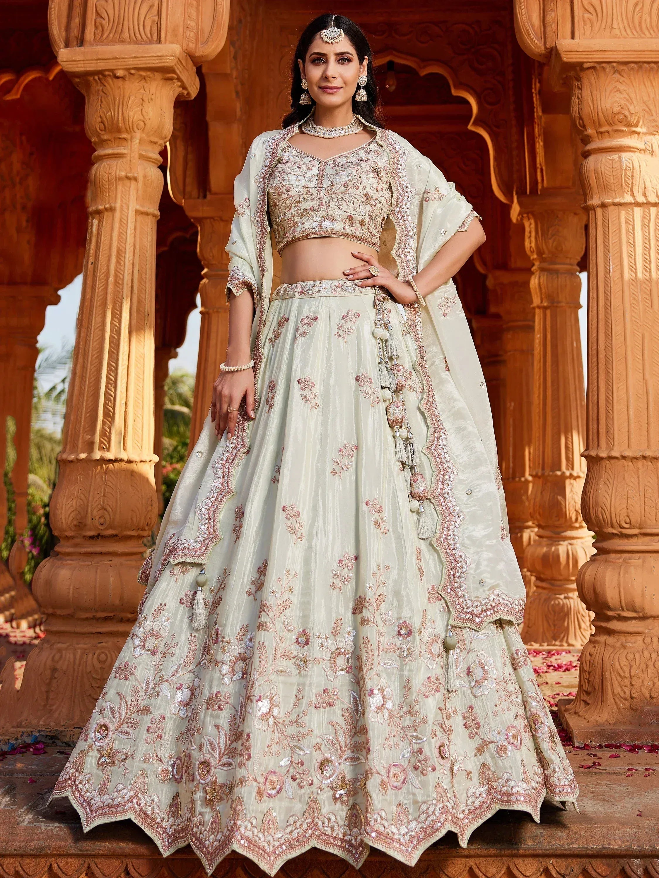 Elegant ivory lehenga choli with floral embroidery, perfect for Indian weddings and festive occasions.