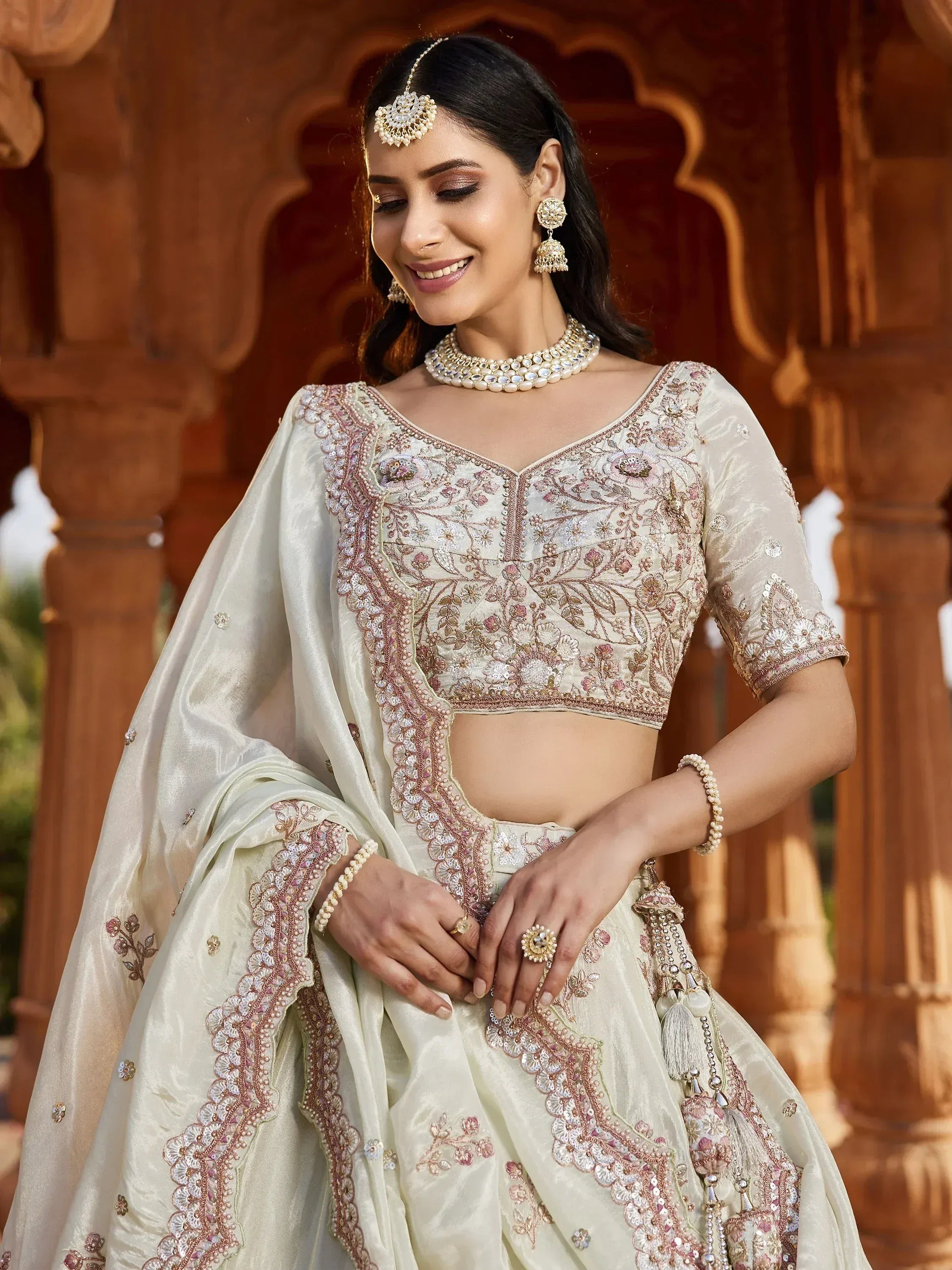 Elegant ivory lehenga choli with floral embroidery, perfect for Indian weddings and festive occasions.