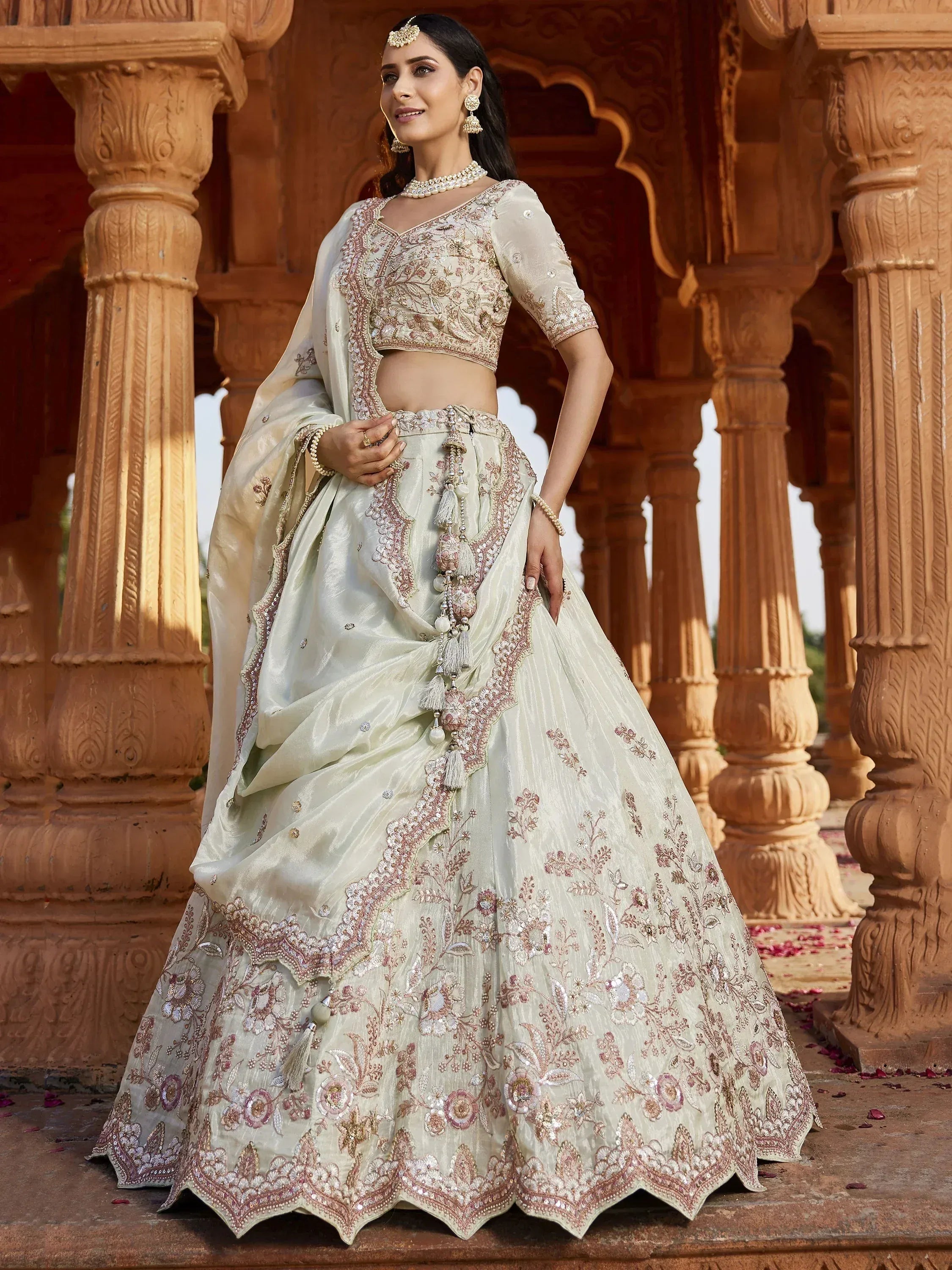 Elegant ivory lehenga choli with floral embroidery, perfect for Indian weddings and festive occasions.