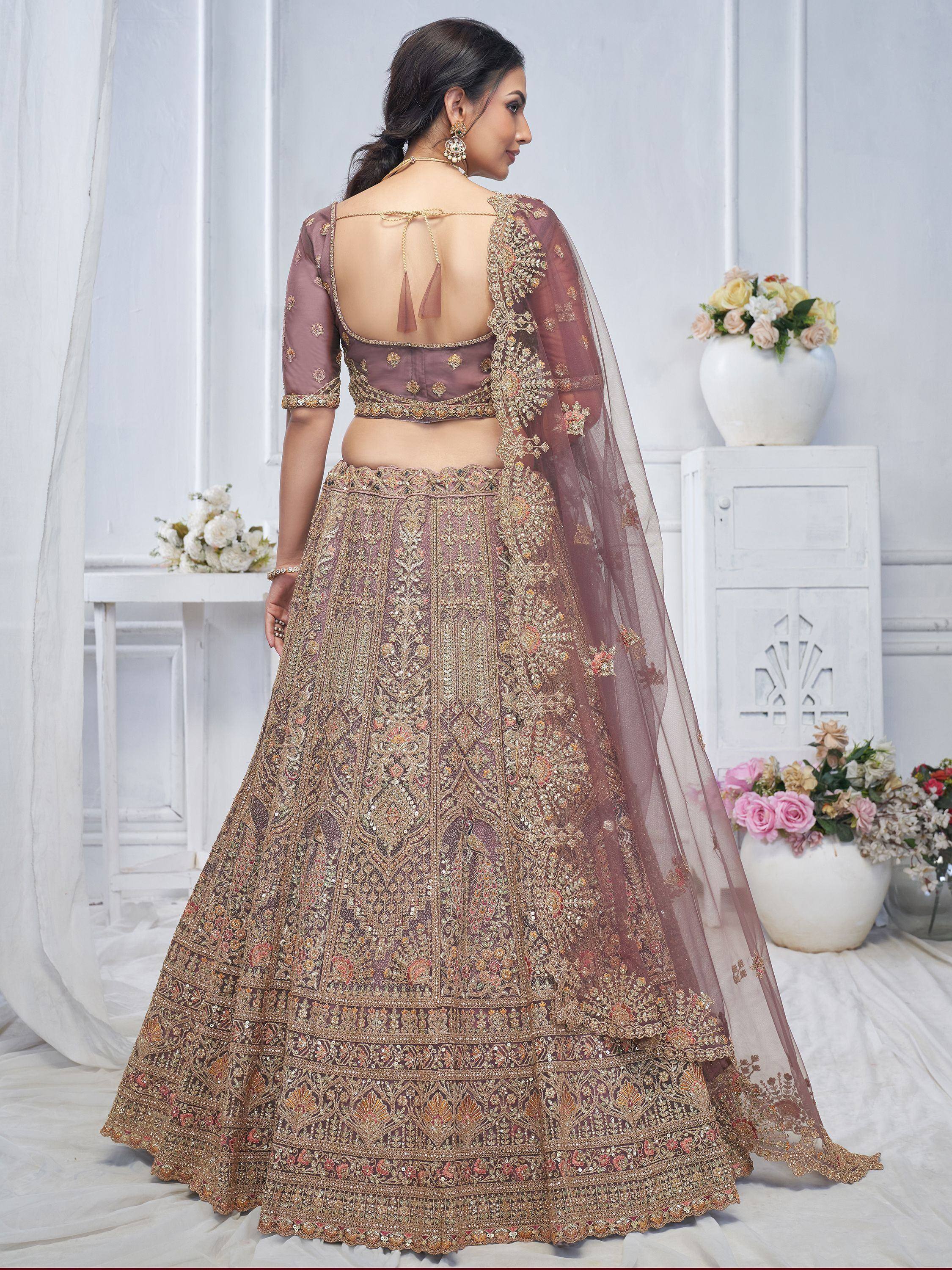 Elegant mauve lehenga choli with intricate gold embroidery and sheer dupatta, perfect for Indian weddings.