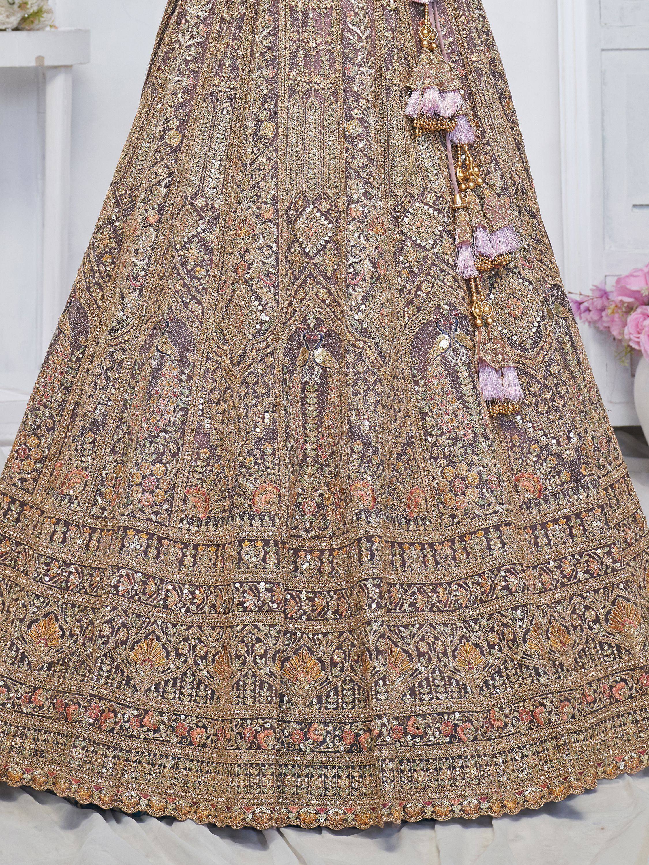Luxury Indian bridal lehenga with intricate gold embroidery, floral motifs, and tassels for wedding wear
