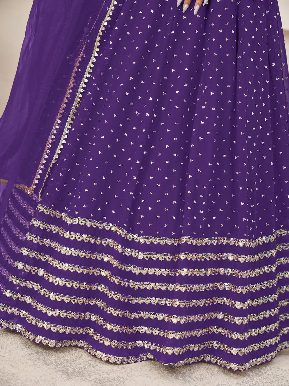 Purple ethnic lehenga with gold sequin embroidery and scalloped borders, perfect for Indian weddings and festive occasions.
