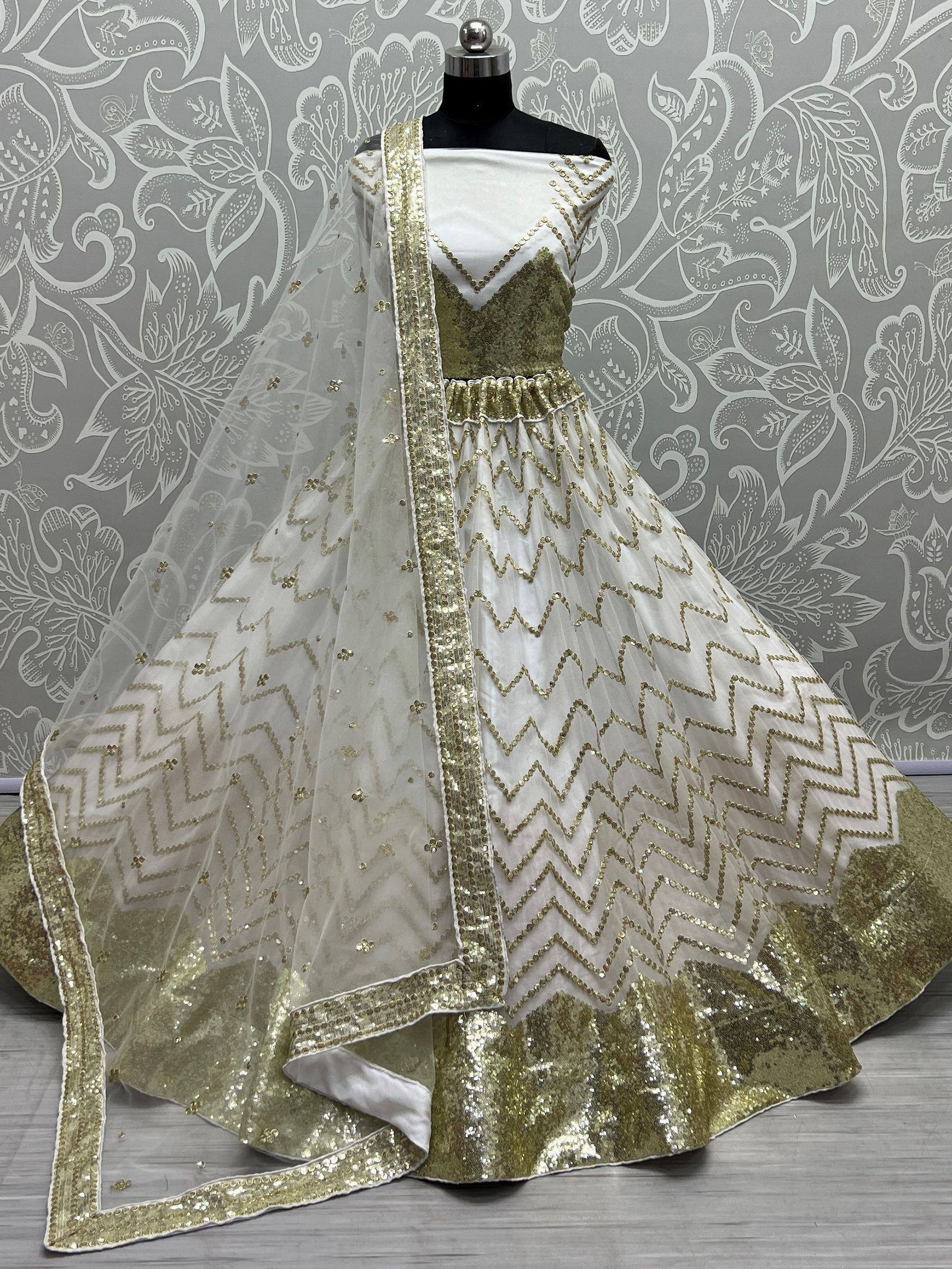 White and gold sequin lehenga choli with zigzag embroidery and matching dupatta, ideal for Indian ethnic wear events.