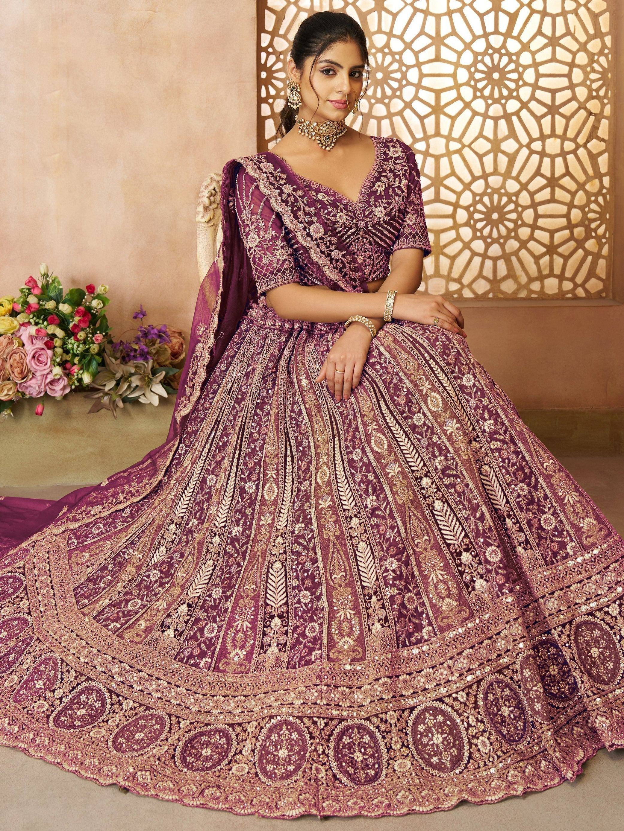 Elegant purple designer lehenga choli with intricate gold embroidery, perfect for Indian weddings and festive occasions.