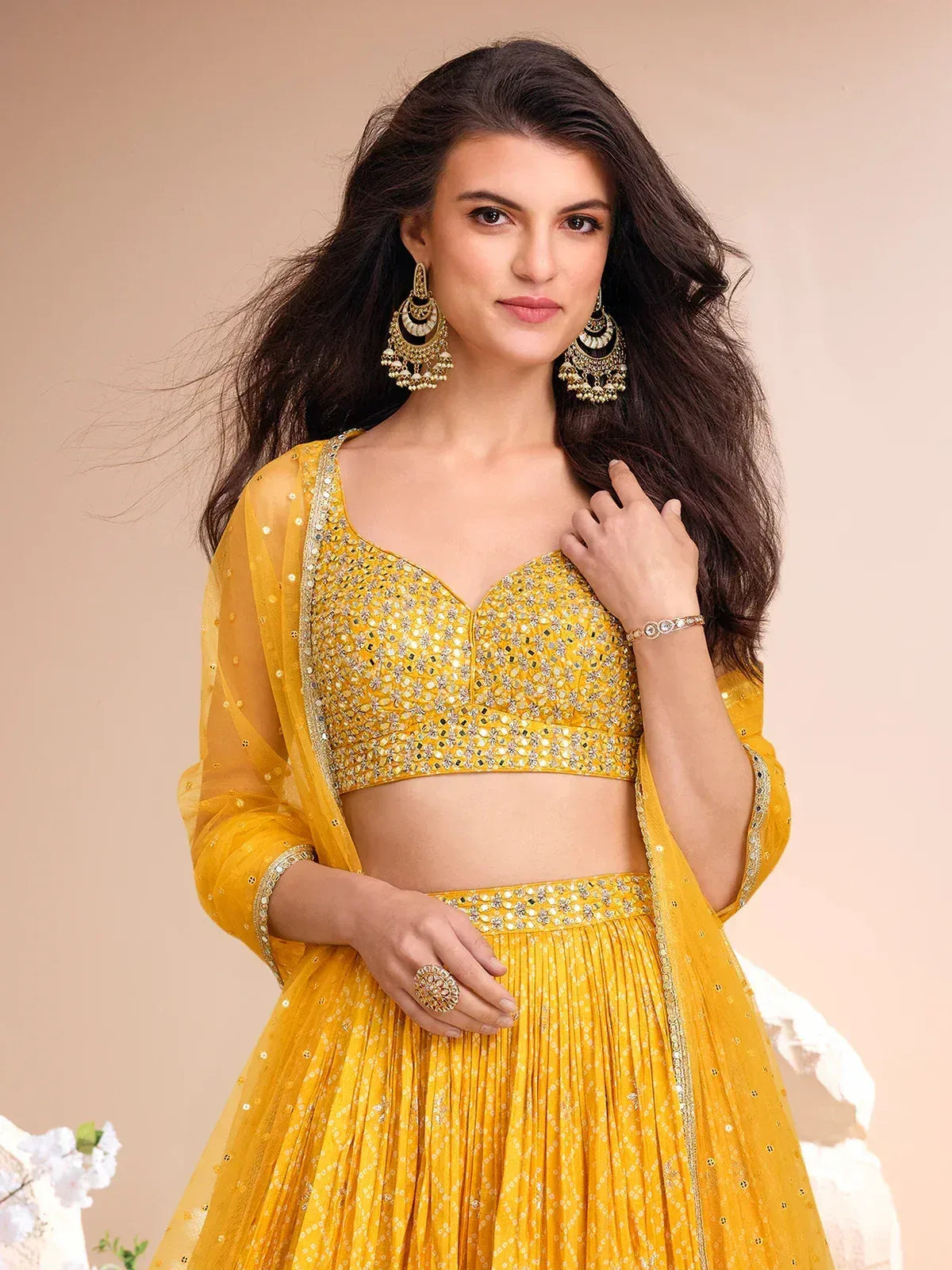 Yellow designer lehenga choli with mirror work, perfect for Indian ethnic wear and festive occasions.
