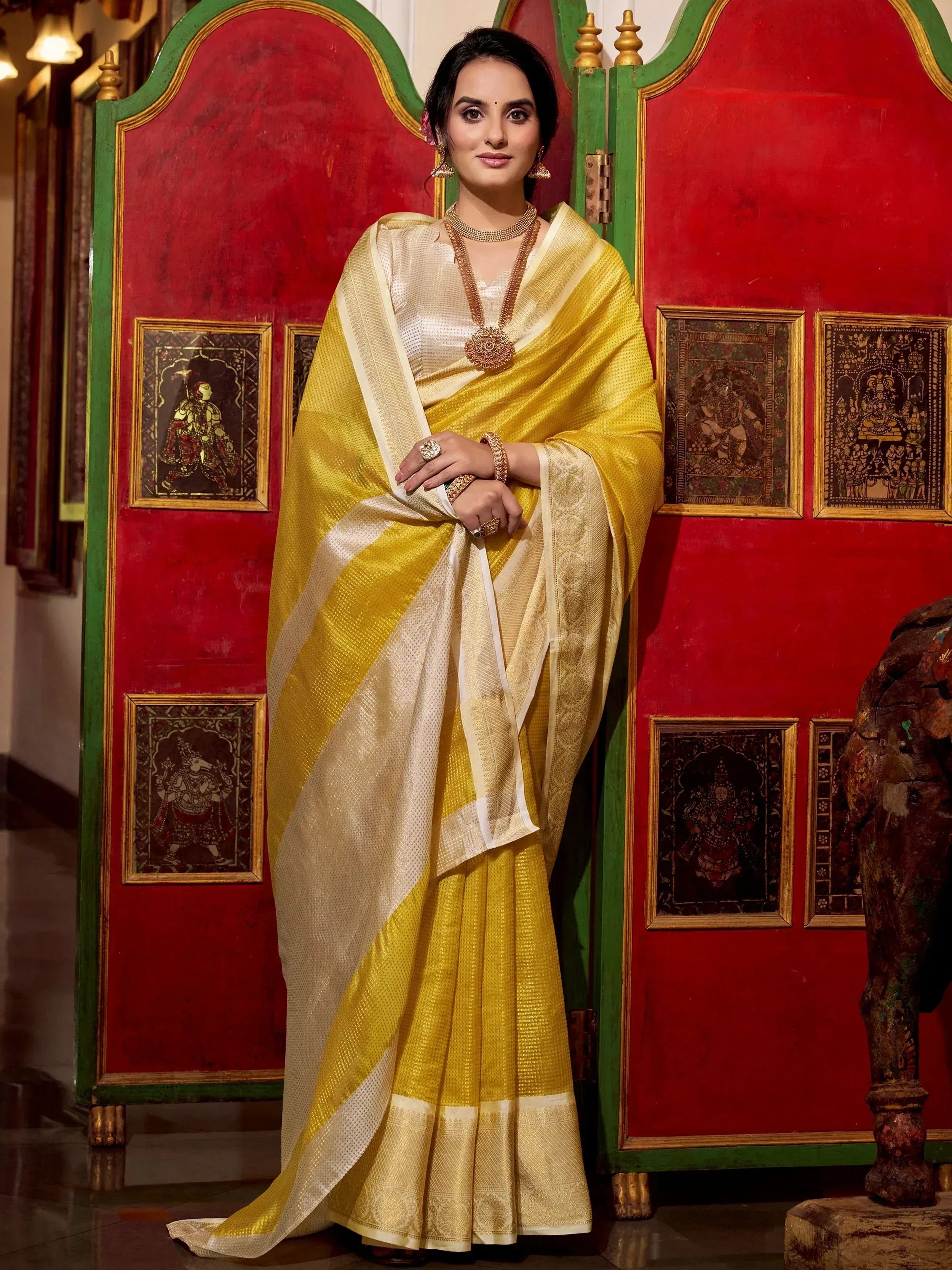 Yellow and cream designer saree with gold jewelry, traditional Indian ethnic wear
