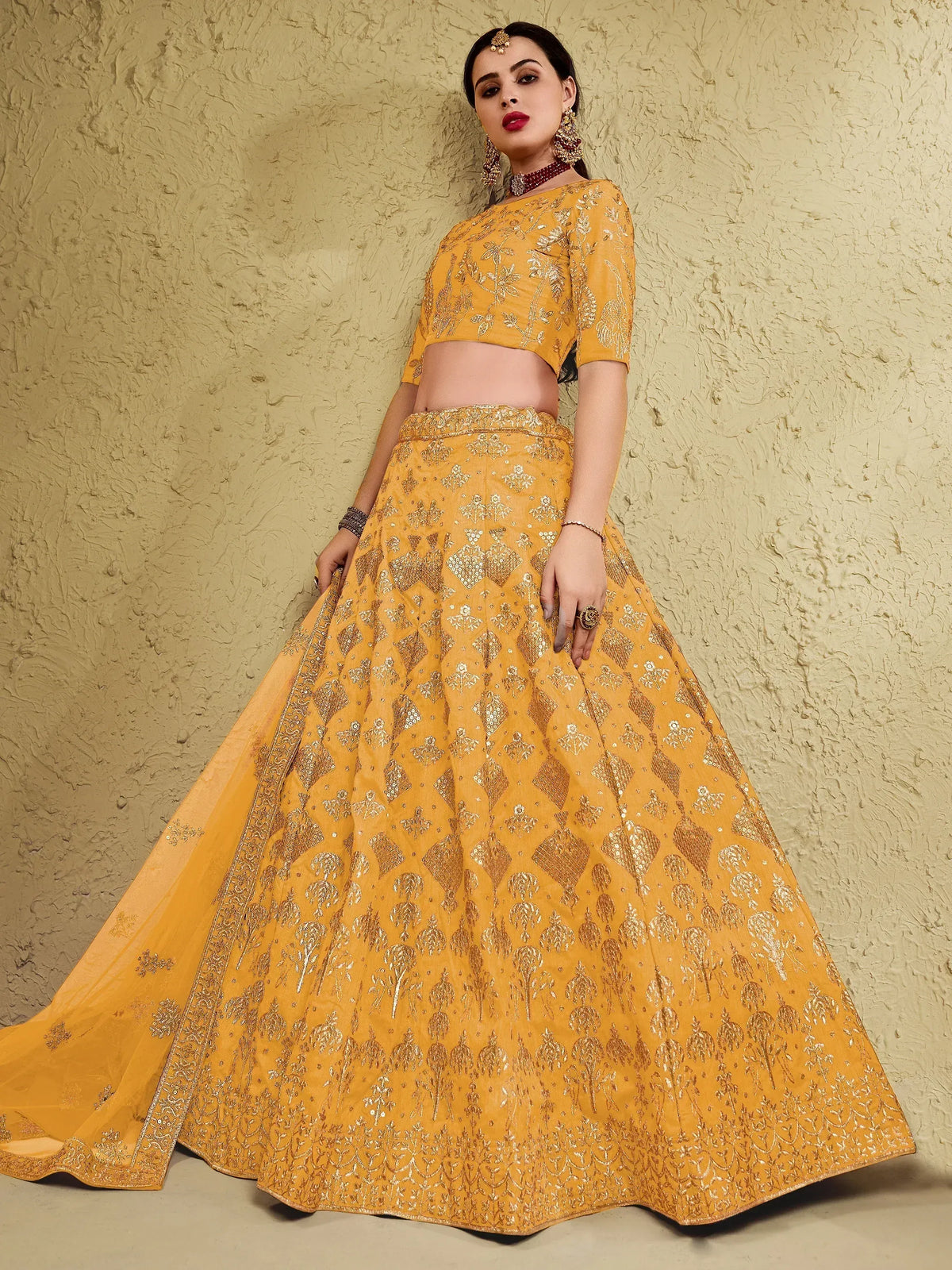 Yellow designer lehenga choli with gold embroidery, perfect for Indian weddings and festive occasions