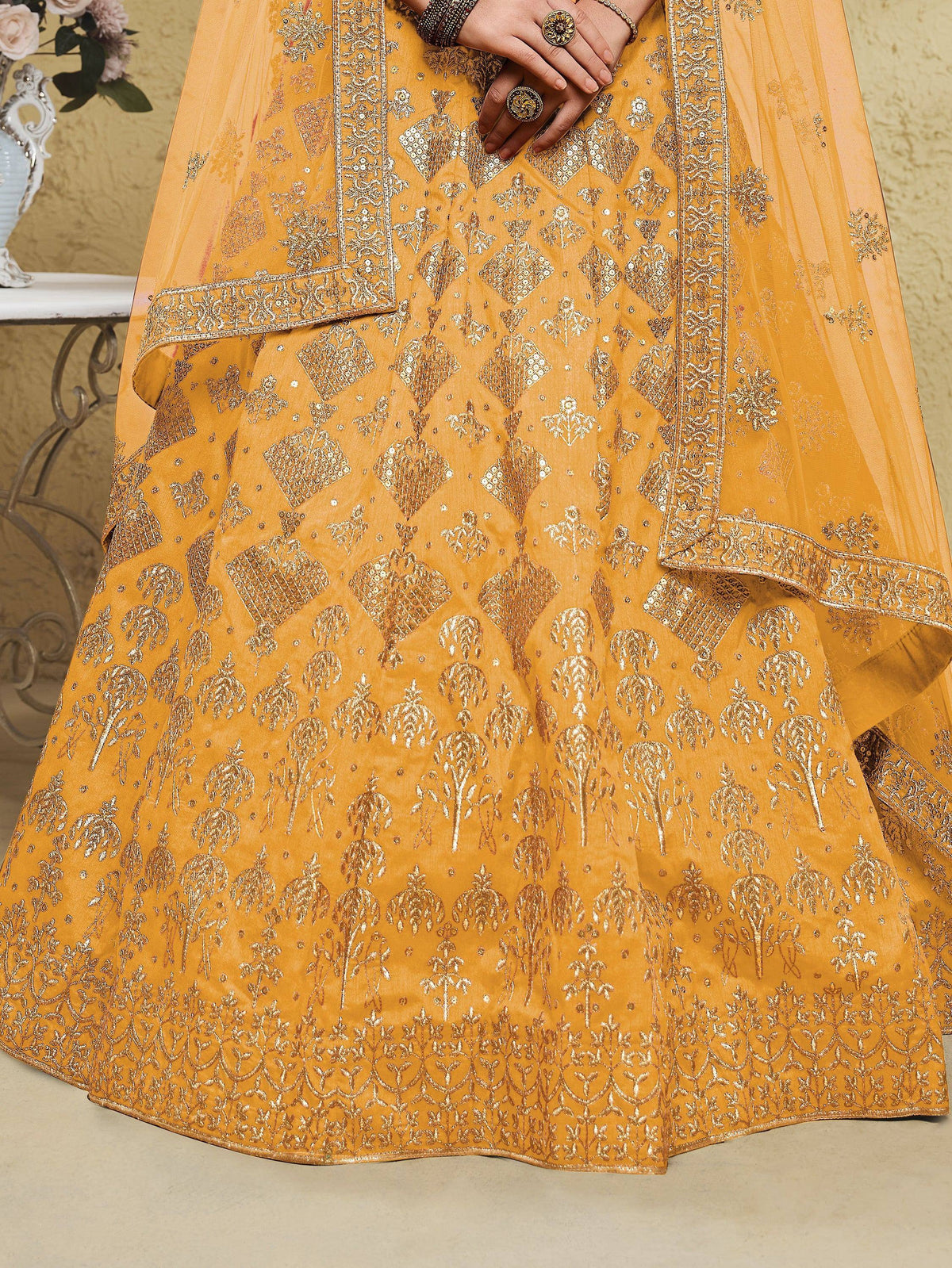Mustard yellow lehenga choli with intricate gold embroidery and sequin work, perfect for Indian ethnic occasions.