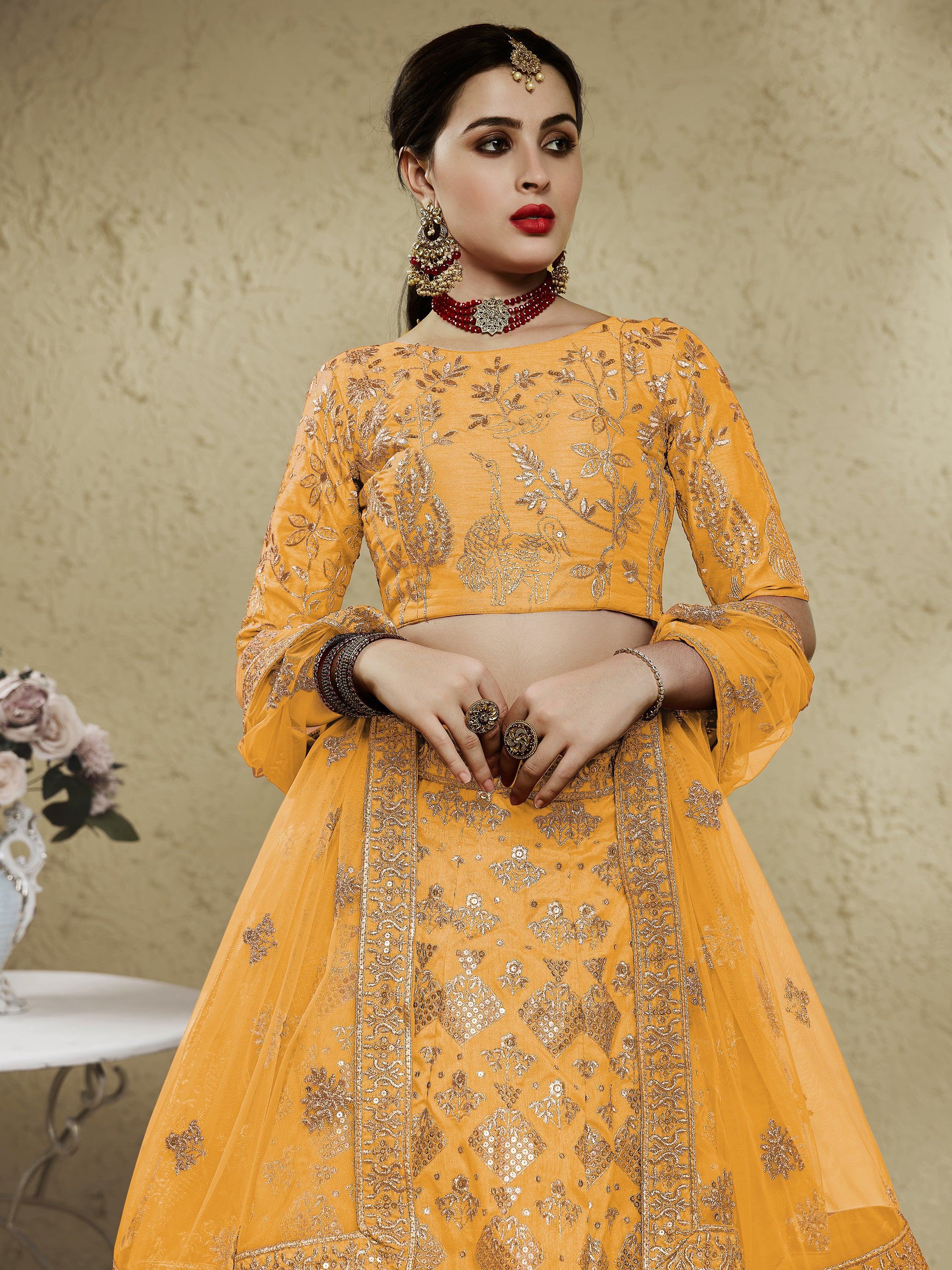 Yellow embroidered lehenga choli with peacock motifs, perfect for Indian ethnic wear and festive occasions.