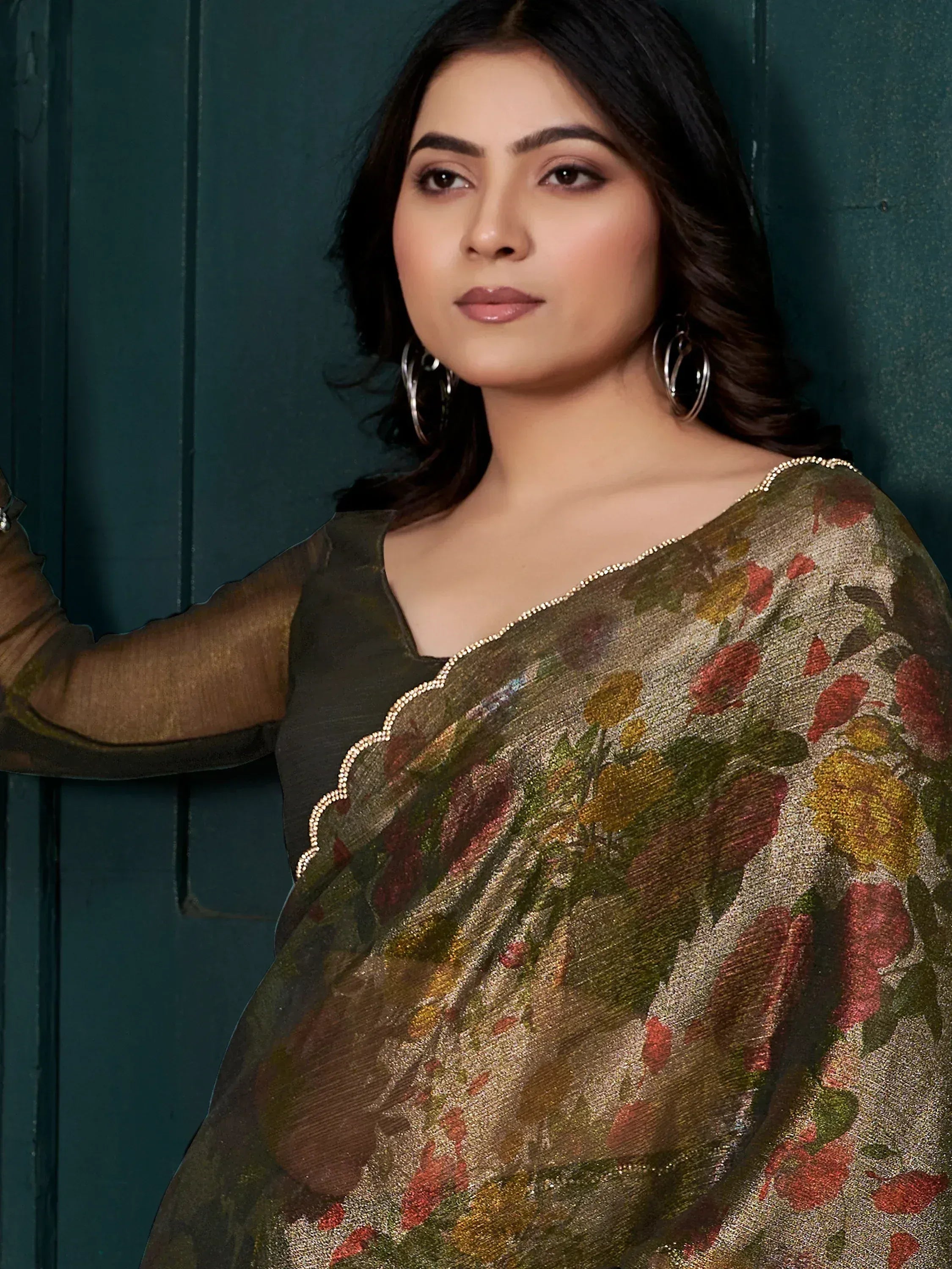 Elegant floral printed saree with golden border, paired with sheer blouse, perfect for Indian ethnic occasions