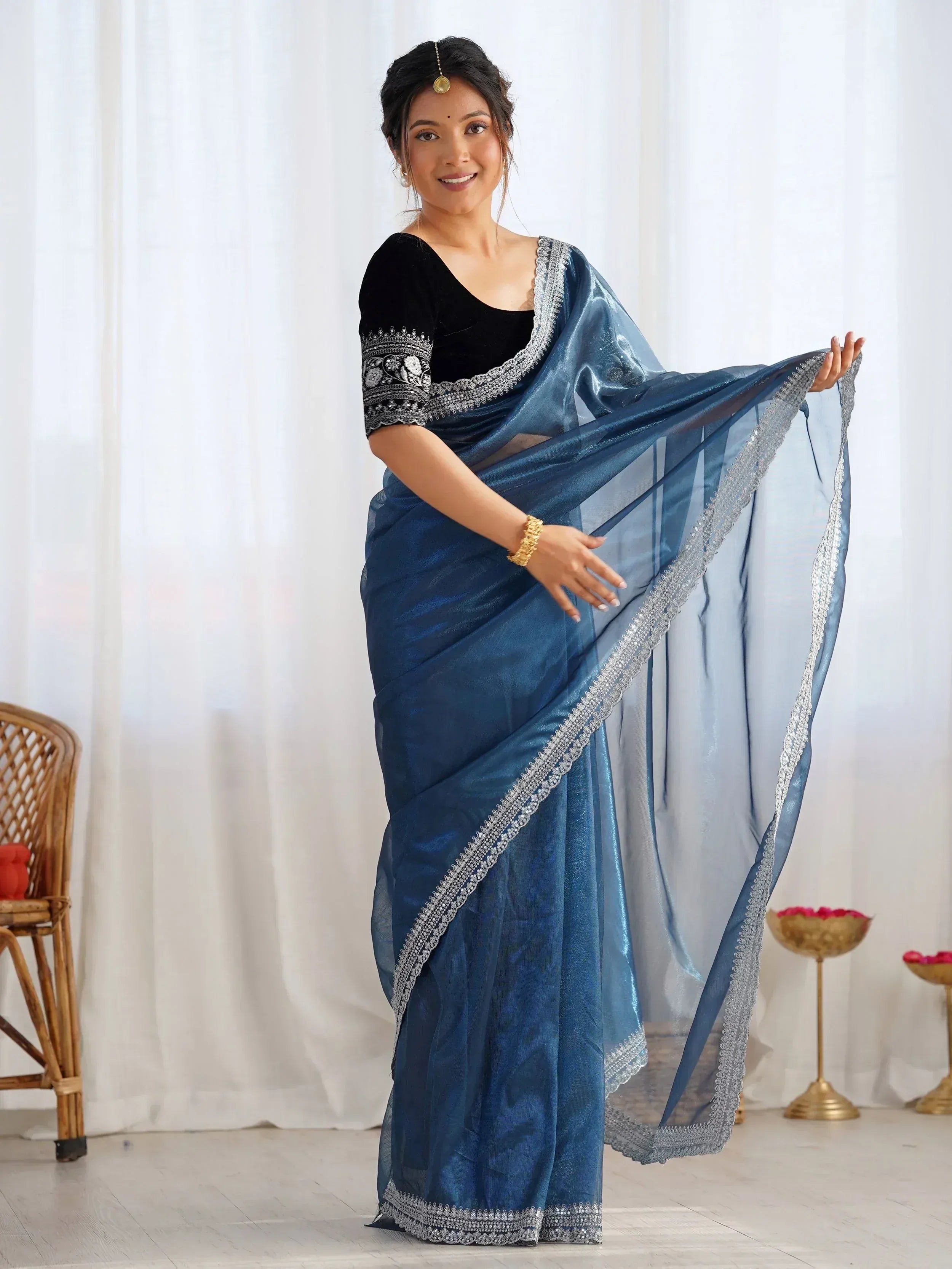 Blue silk saree with silver embroidery, paired with black velvet blouse, ideal for Indian ethnic occasions.