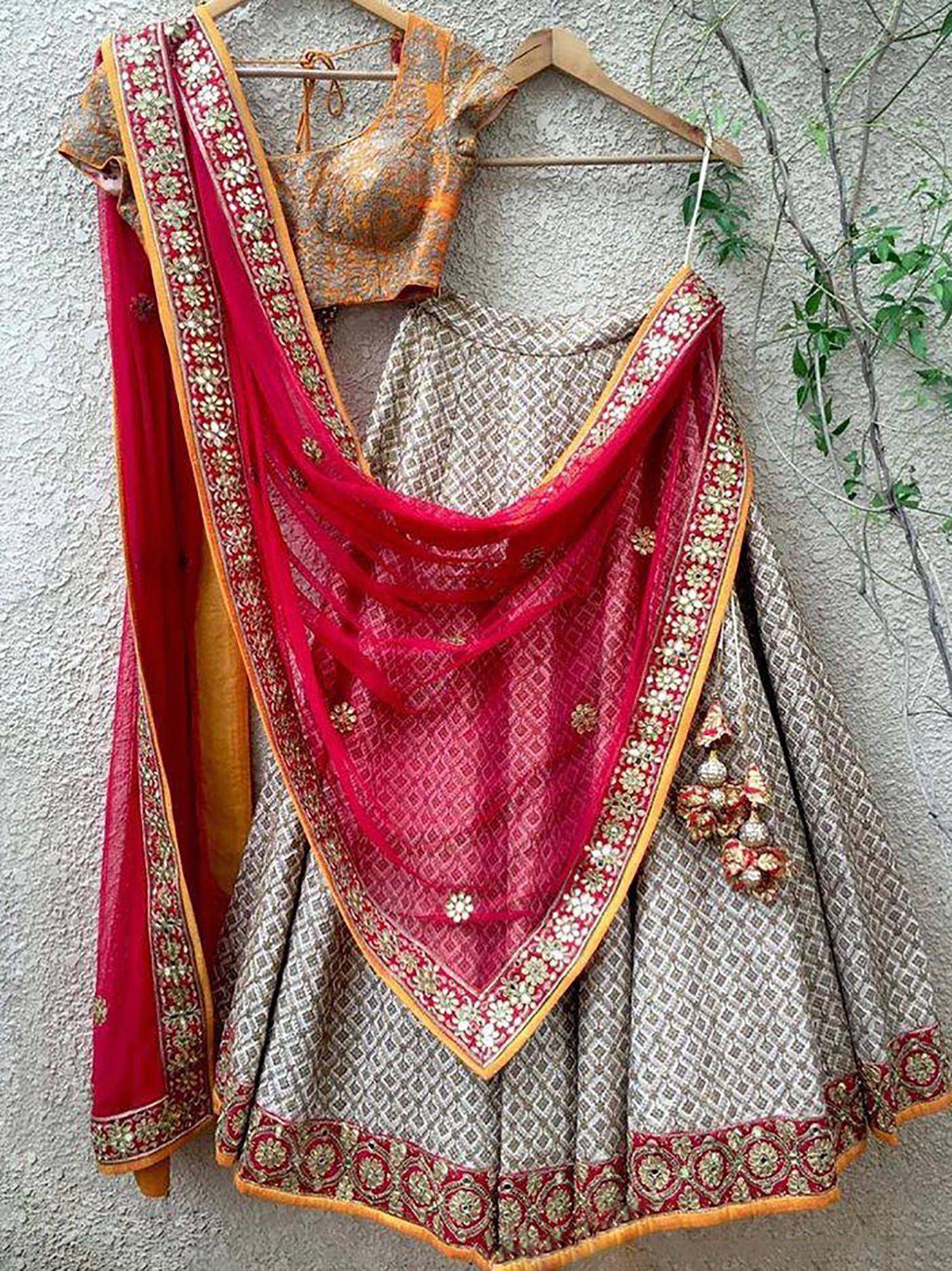 Designer lehenga choli with red dupatta, gold embroidery, and patterned skirt for Indian ethnic wear