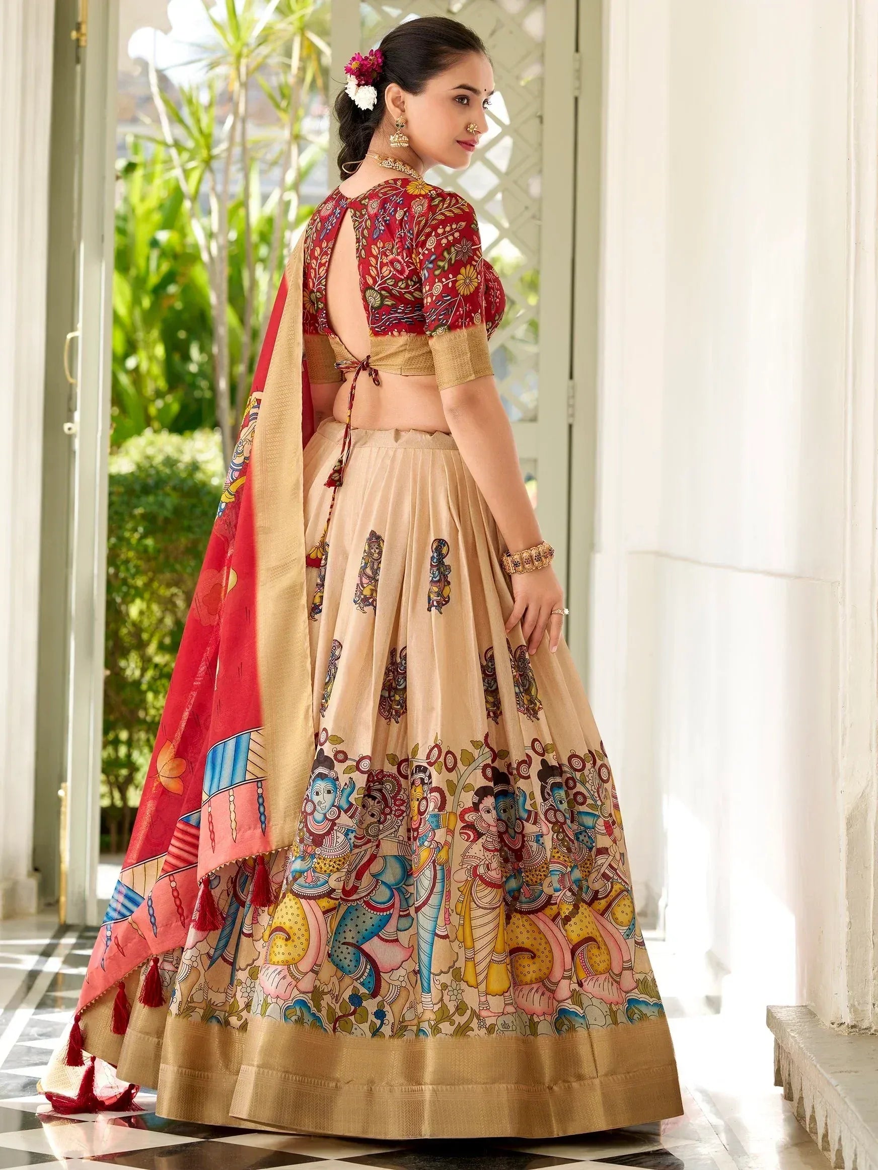 Woman in designer lehenga choli with floral and deity prints, perfect for Indian ethnic wear occasions