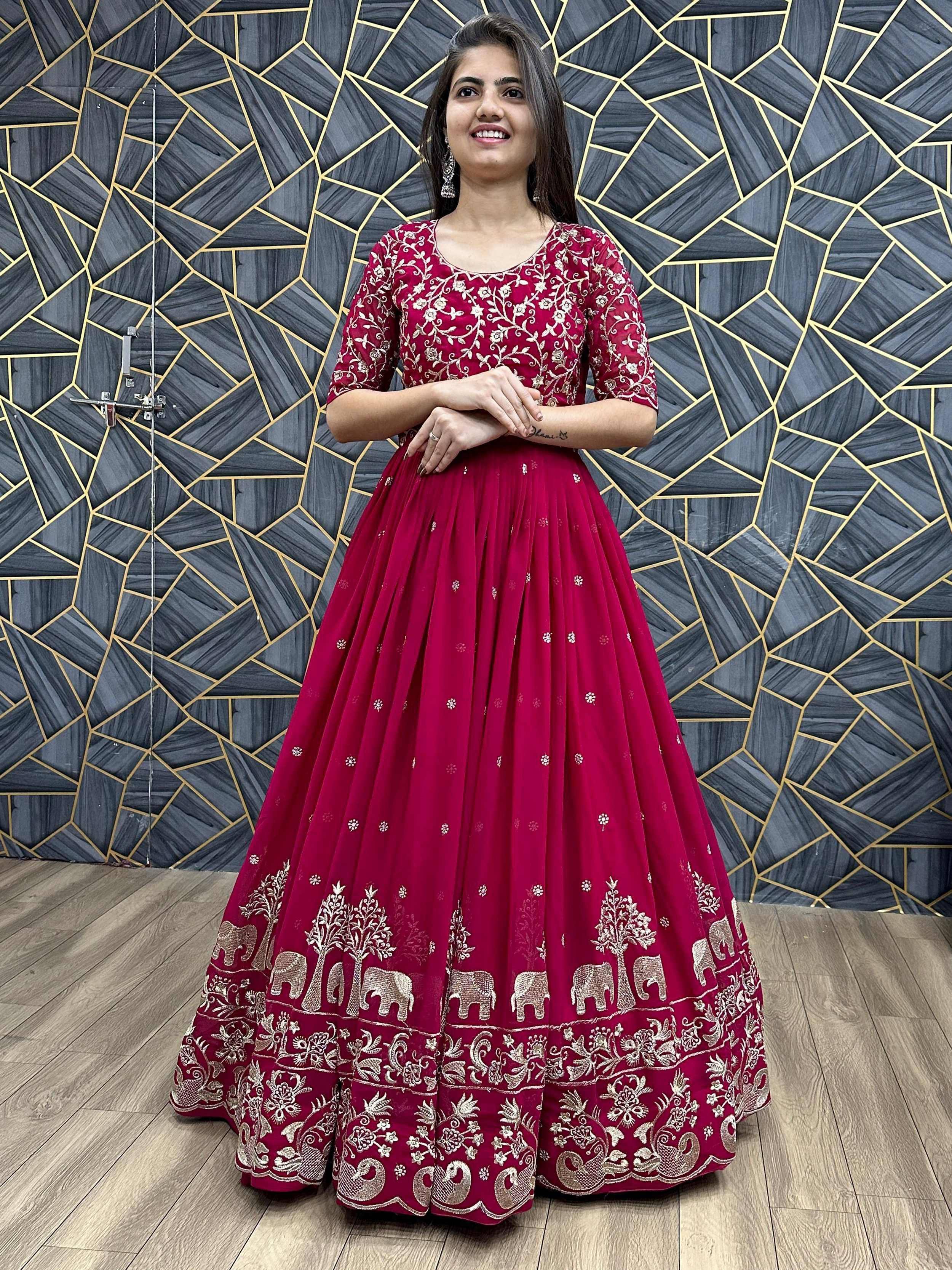 Woman in maroon embroidered lehenga choli with elephant and peacock motifs, ideal for Indian ethnic wear occasions.