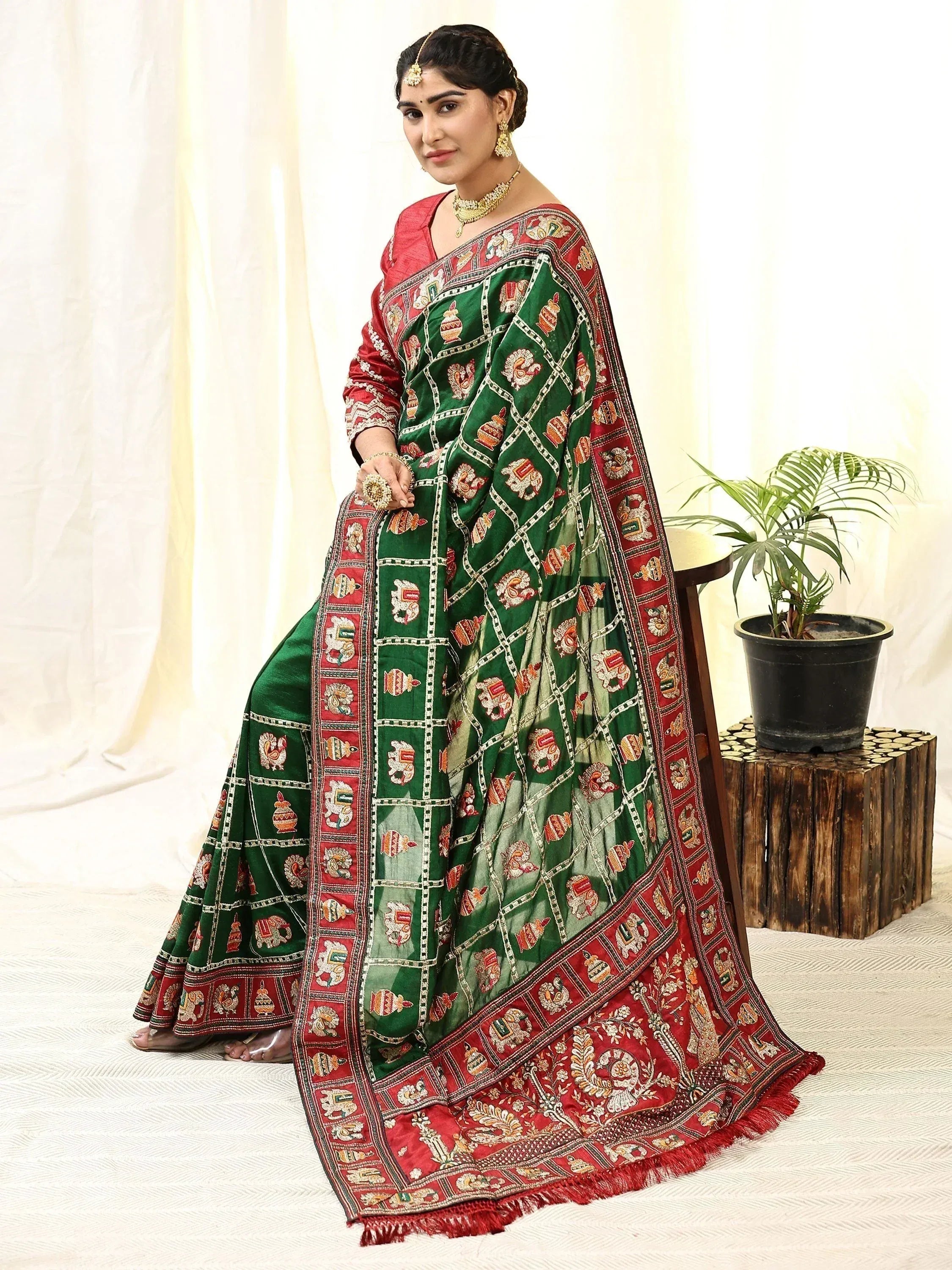 Green and red embroidered lehenga choli with traditional motifs, perfect for Indian ethnic wear occasions.