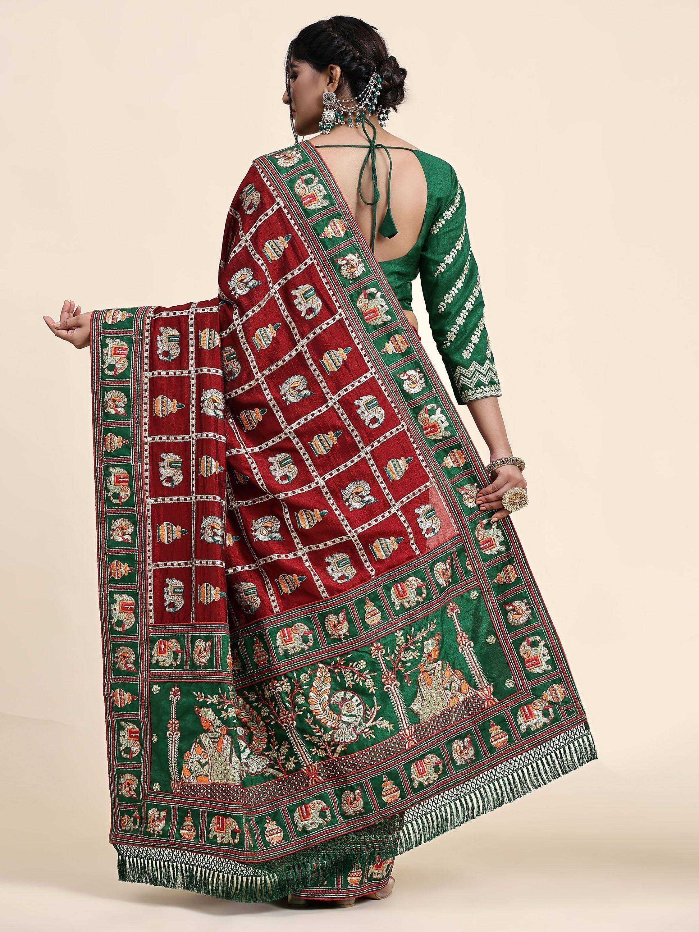 Woman in green and maroon embroidered saree with elephant motifs, traditional Indian ethnic wear