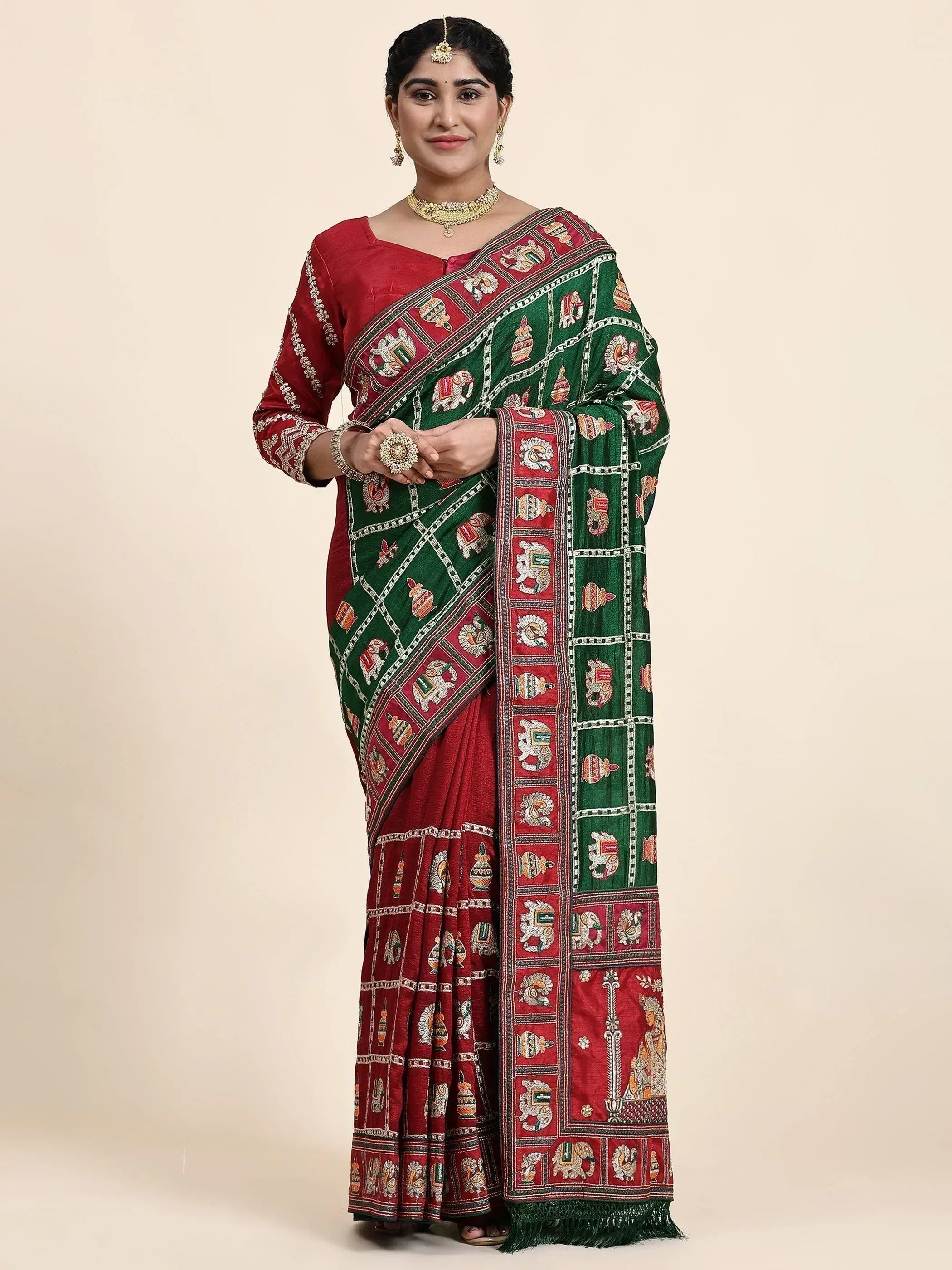 Woman in red and green embroidered saree with elephant motifs, traditional Indian ethnic wear