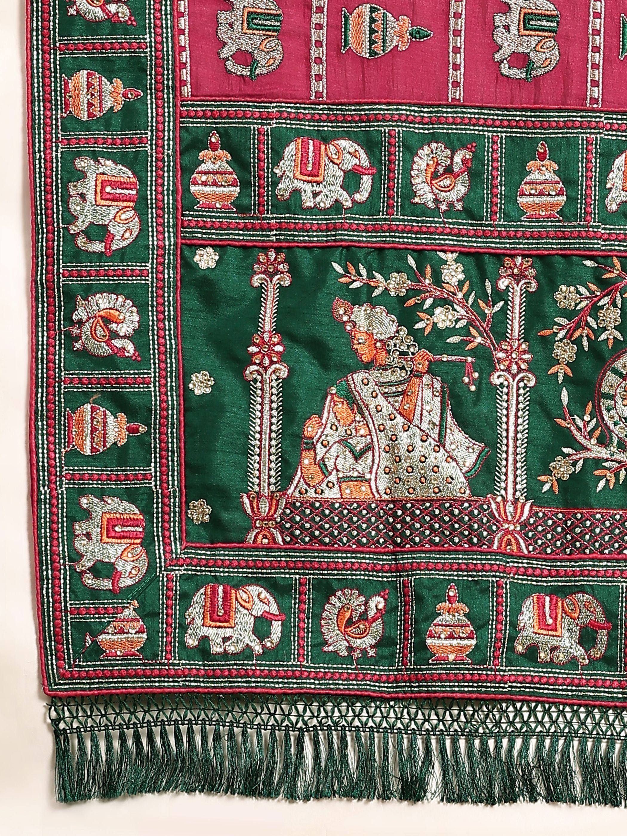 Green and pink embroidered Indian ethnic fabric with elephant, peacock, and deity motifs, perfect for lehenga or saree.