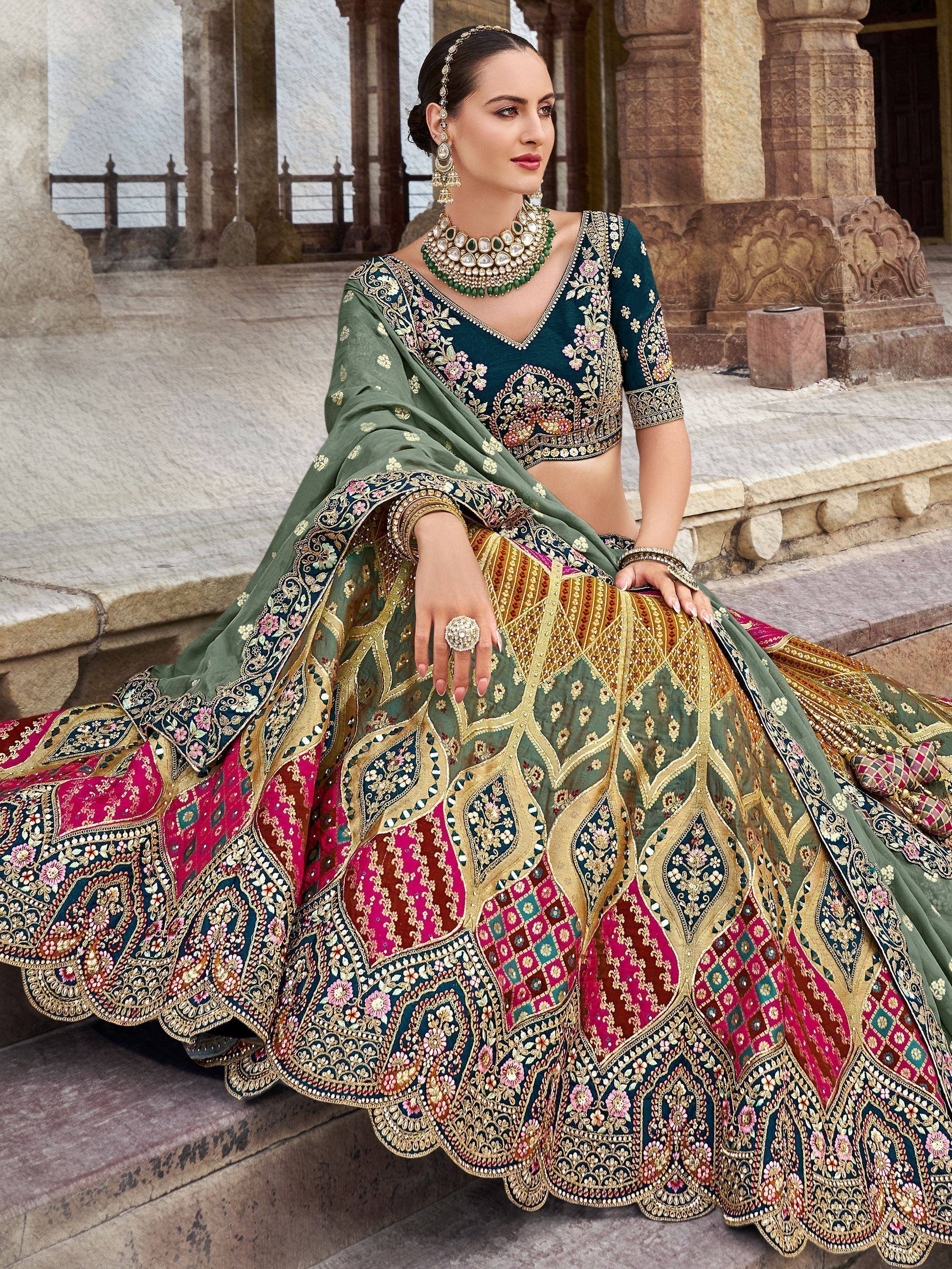Elegant green and pink embroidered lehenga choli with heavy gold work, perfect for Indian weddings and festivals.