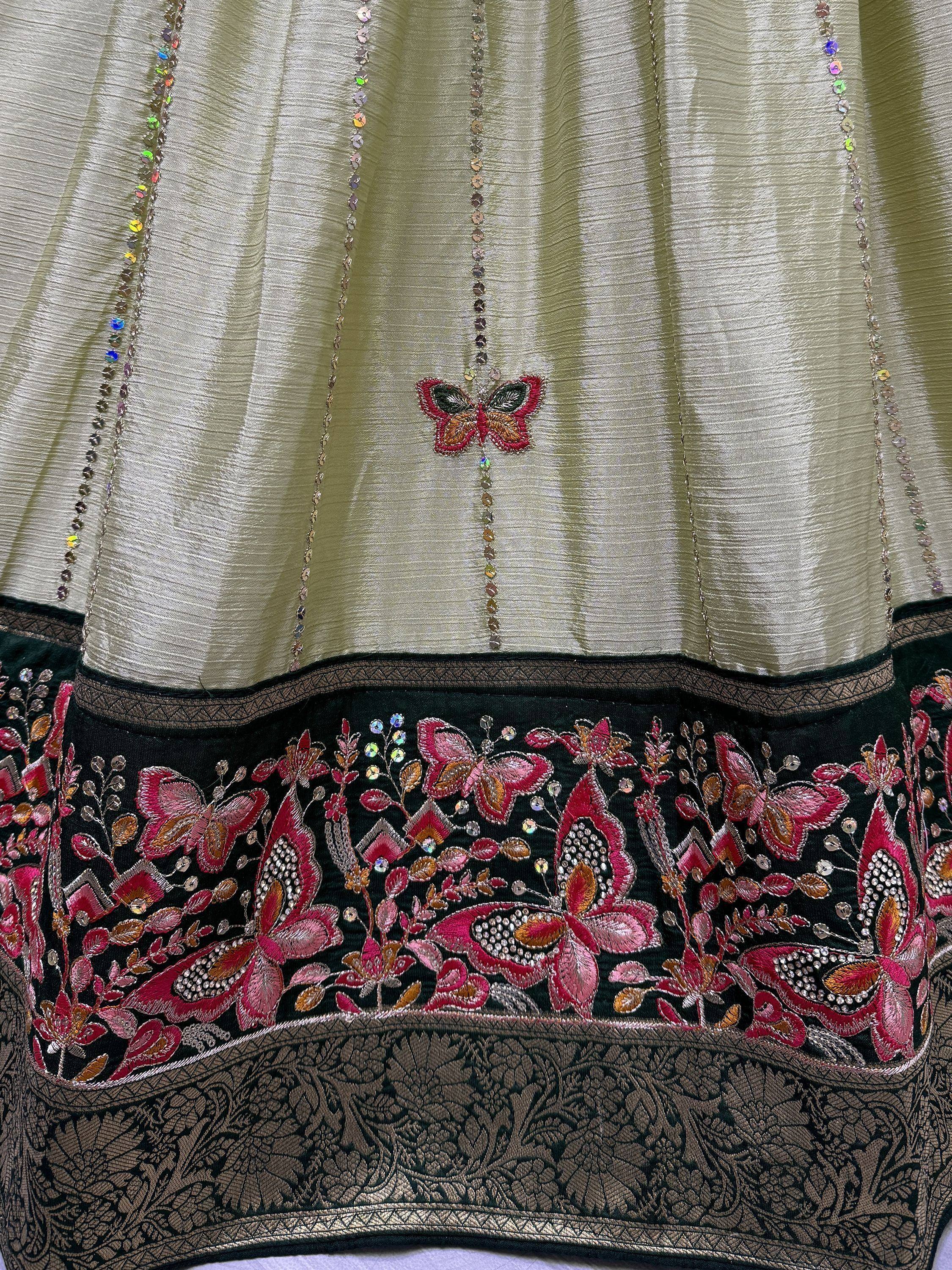 Elegant ethnic gown with butterfly embroidery, sequins, and floral detailing on olive and black fabric