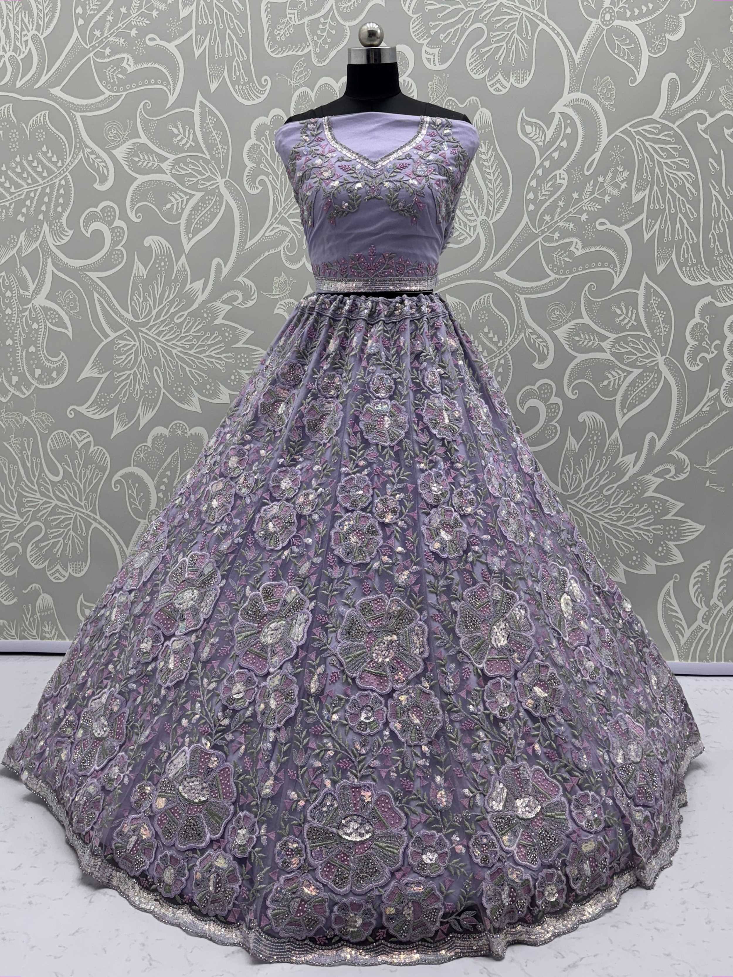 Lavender designer lehenga choli with heavy floral embroidery and sequins, perfect for Indian weddings and parties.