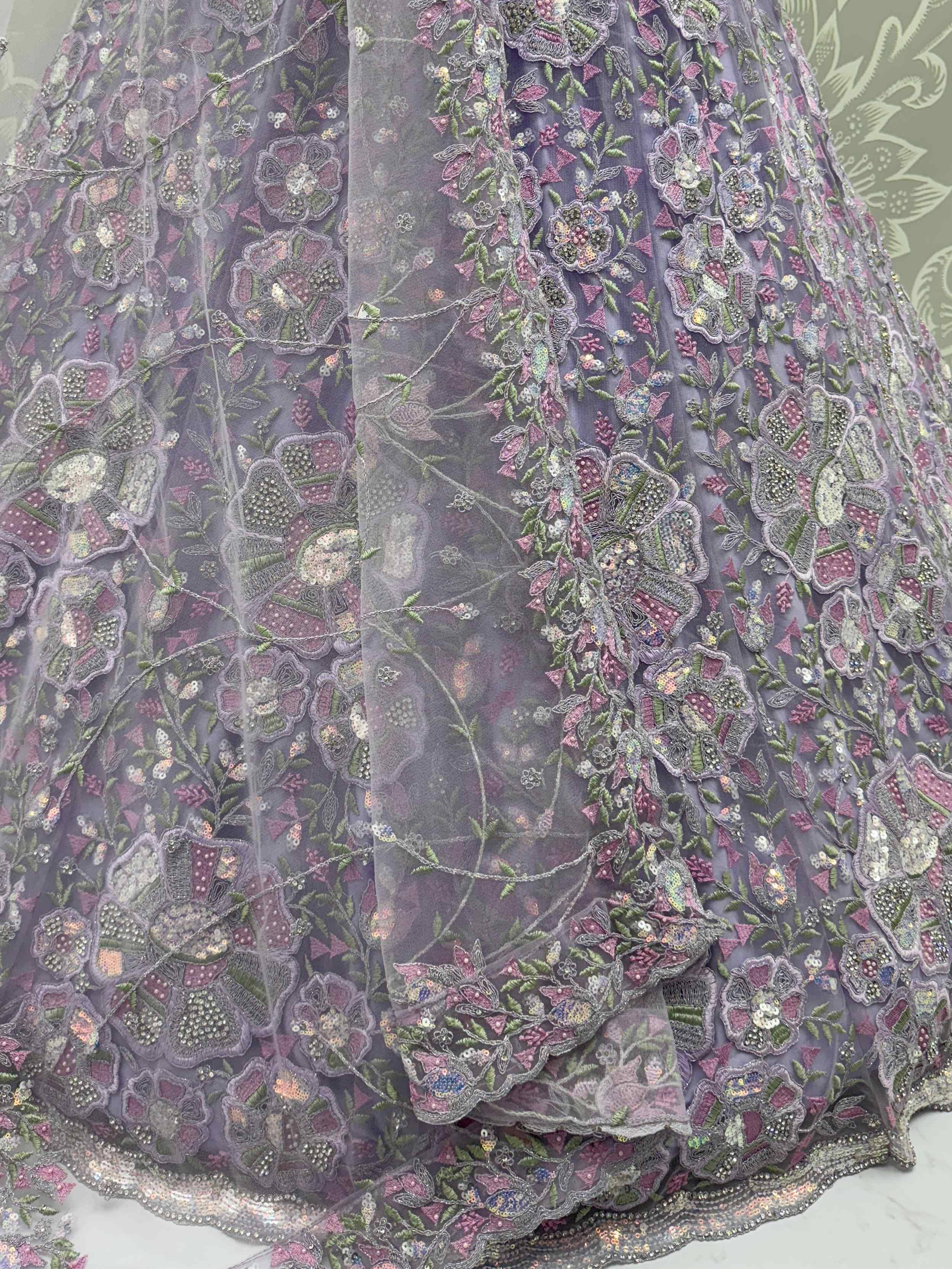 Lavender ethnic gown with floral embroidery and sequins, perfect for Indian celebrations.