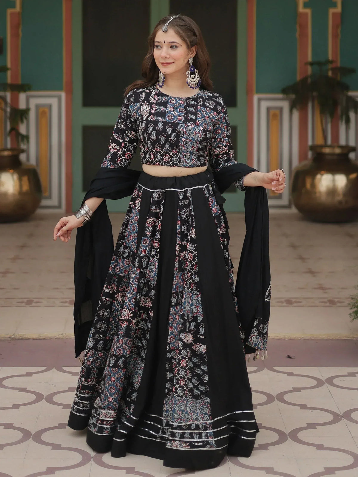 Black printed lehenga choli with floral patterns, perfect for Indian ethnic wear and festive occasions.