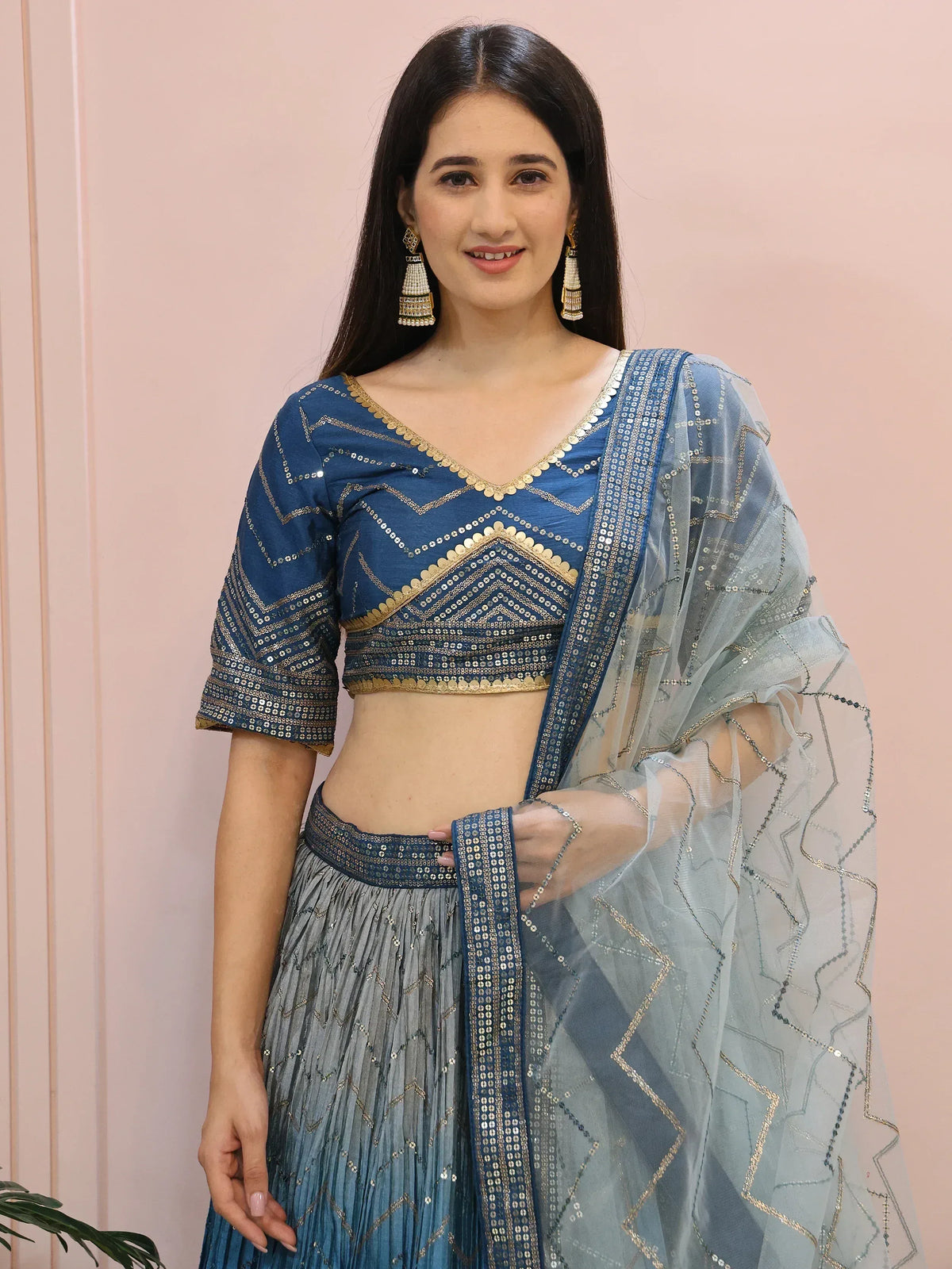 Blue designer lehenga choli with gold mirror work and sheer dupatta, perfect for Indian ethnic occasions