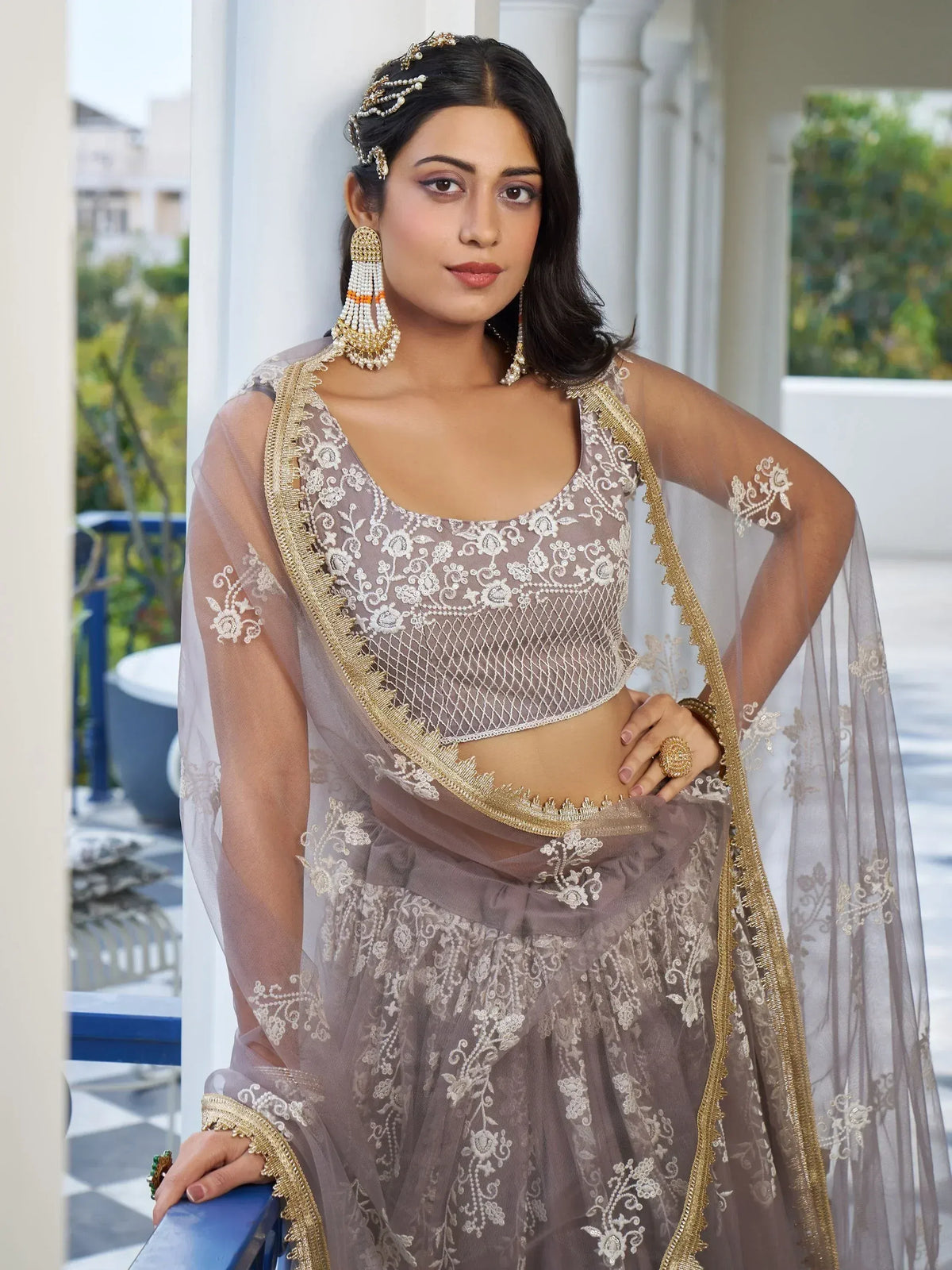 Elegant grey embroidered lehenga choli with gold detailing, perfect for Indian weddings and festive occasions.