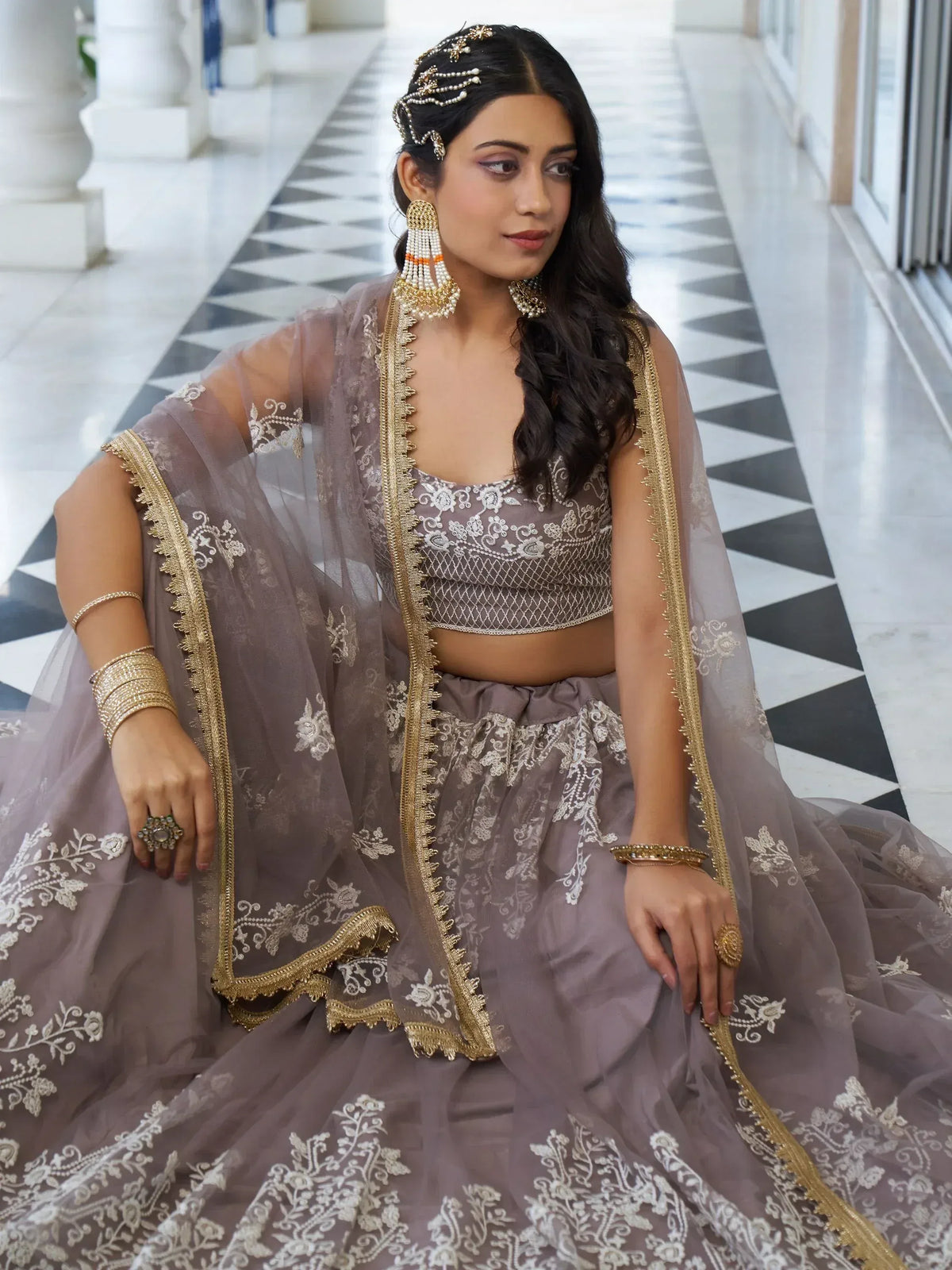 Elegant mauve lehenga choli with gold embroidery, perfect for Indian weddings and festive occasions.