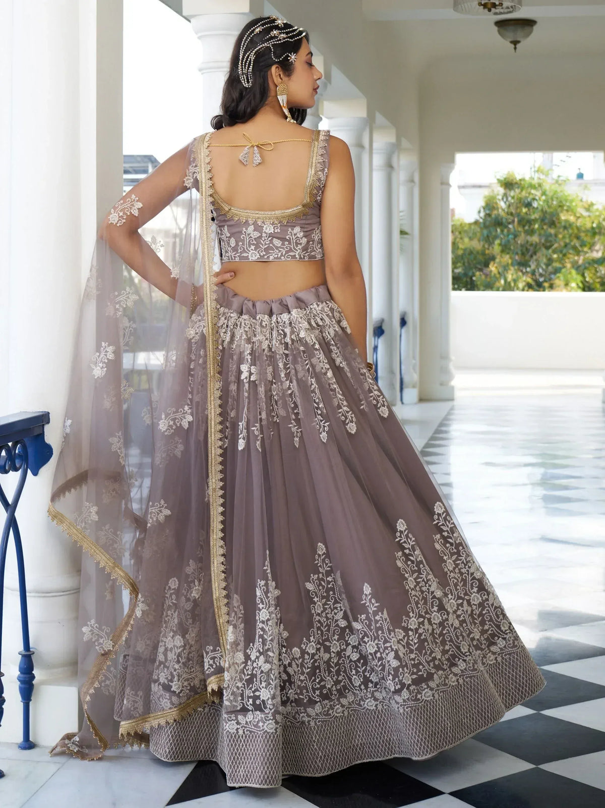 Elegant mauve lehenga choli with gold embroidery, sheer dupatta, and backless blouse for Indian ethnic wear