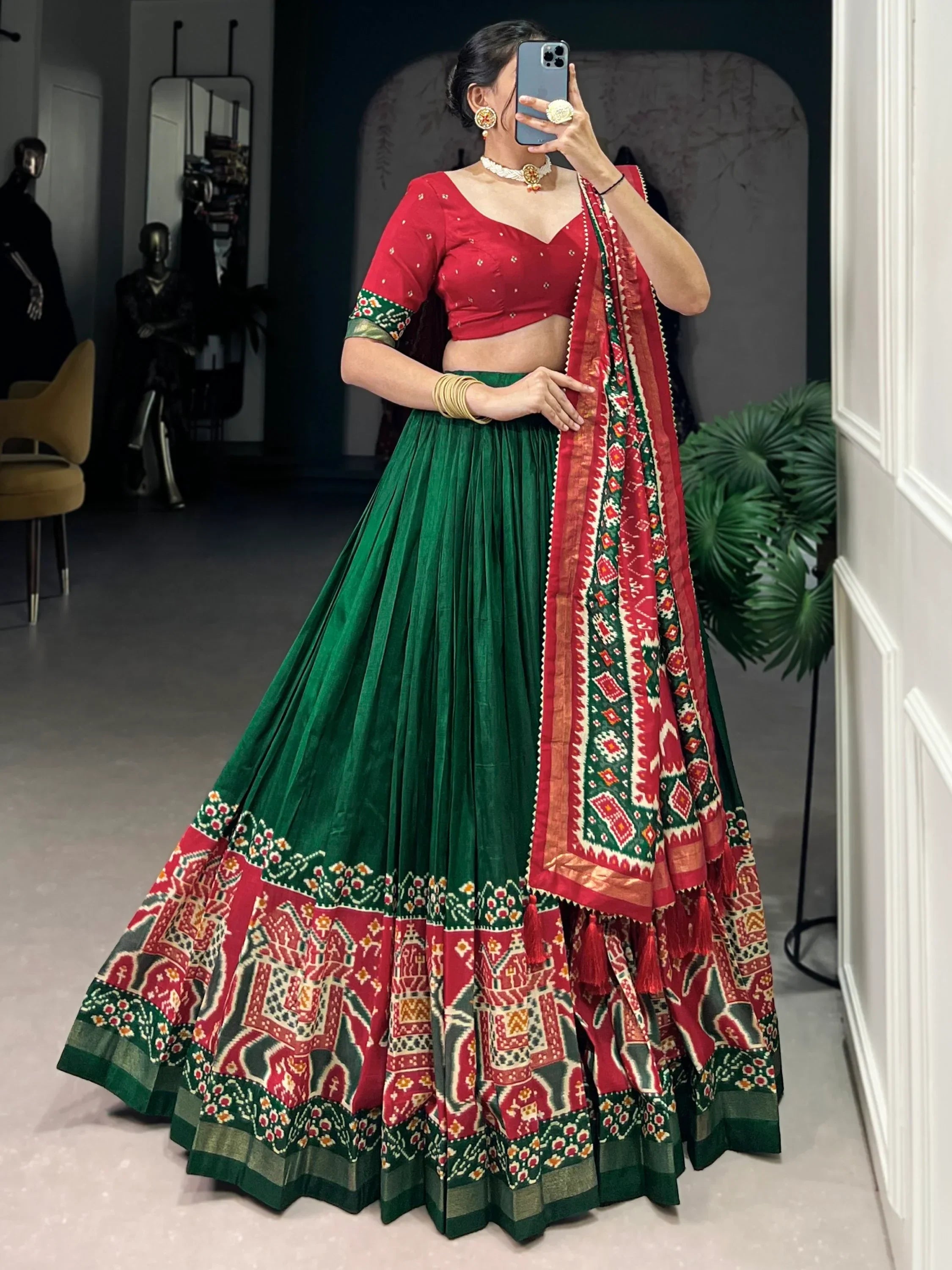 Red and green printed lehenga choli with ethnic motifs, perfect for Indian weddings and festive occasions.
