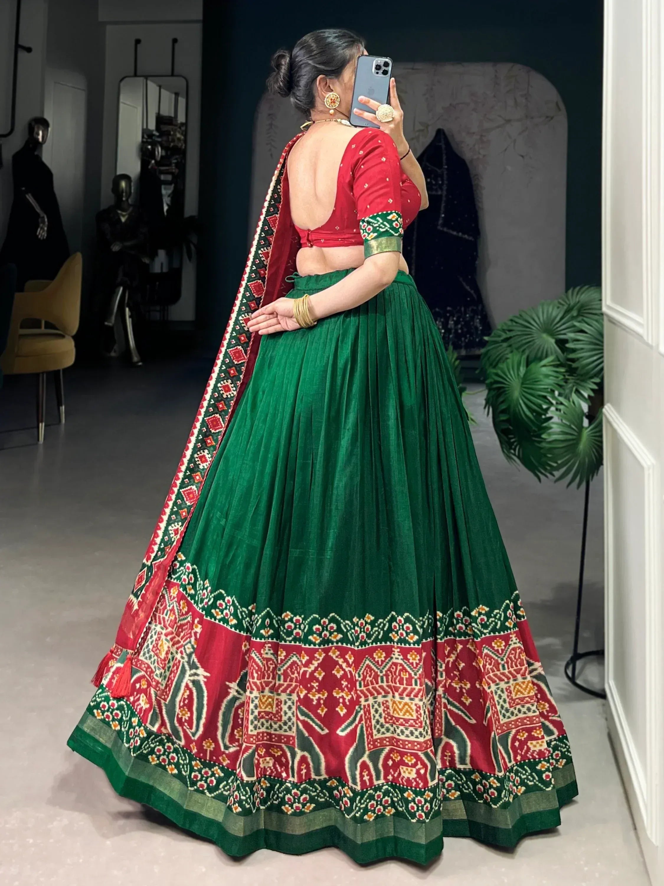 Green and red embroidered lehenga choli with backless blouse, perfect for Indian ethnic wear occasions.