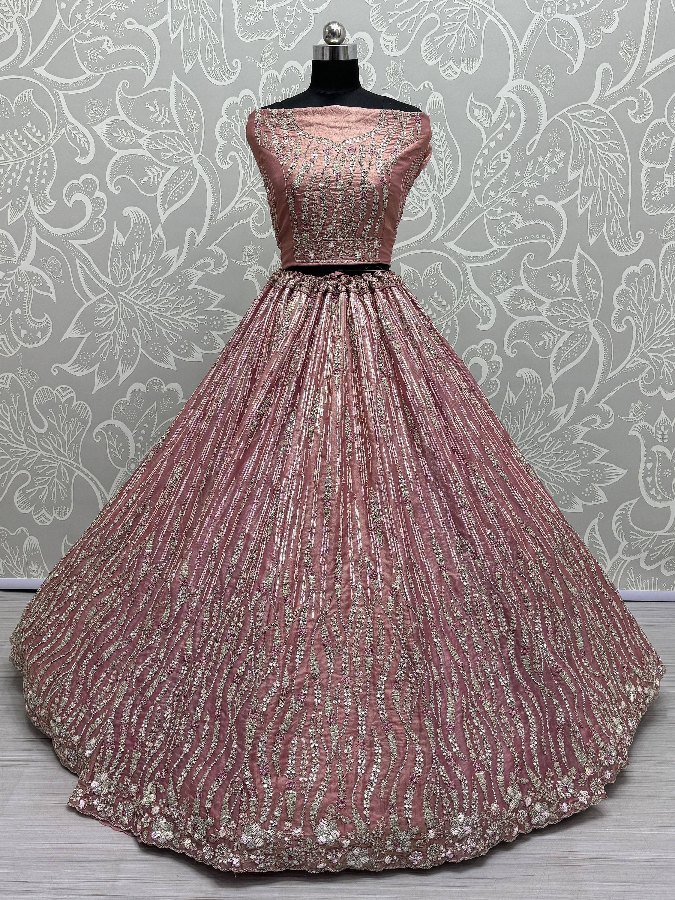 Dusty pink designer lehenga choli with intricate silver embroidery and sequin work, perfect for Indian weddings and festive occasions.