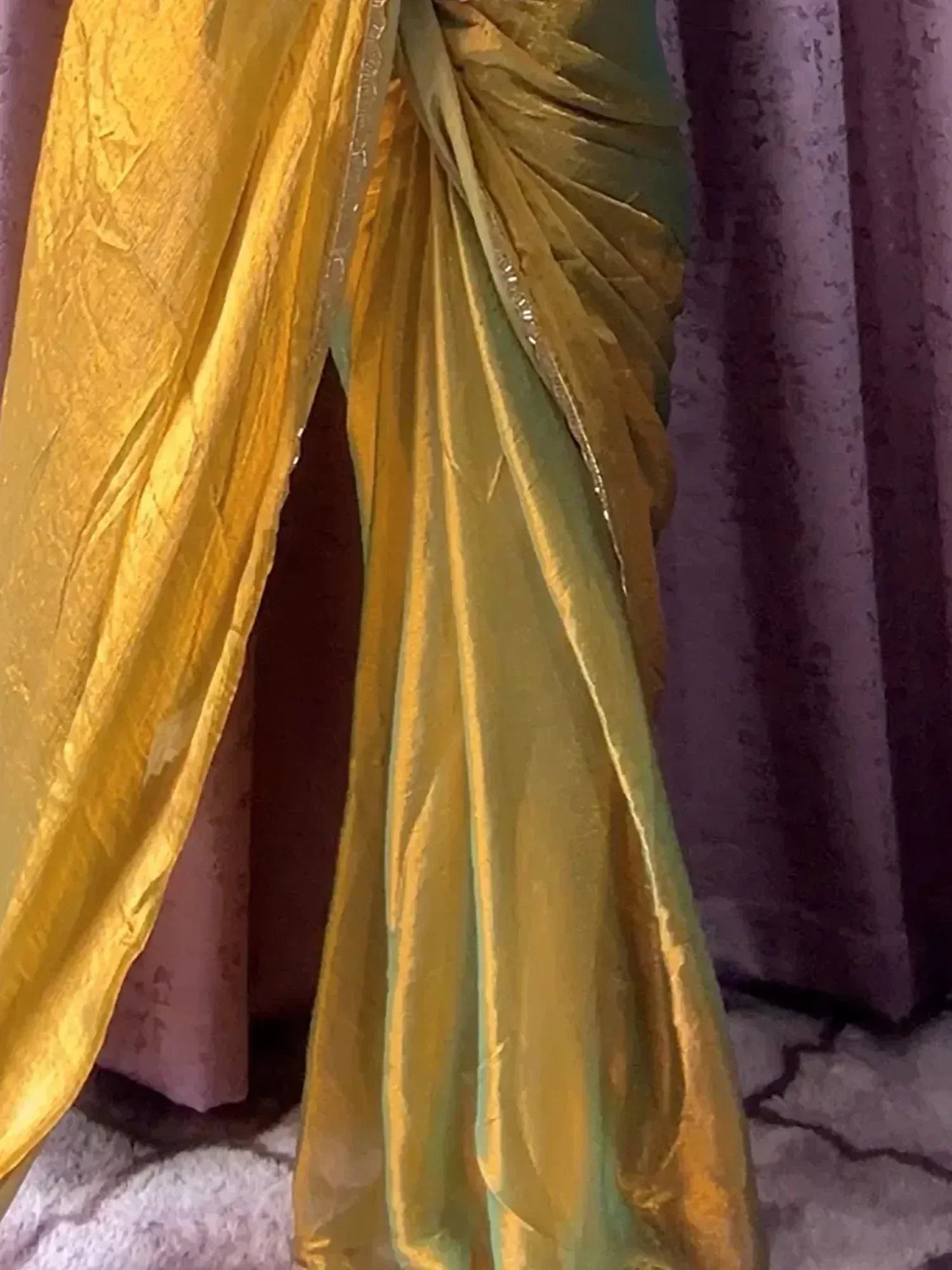 Golden ethnic saree with shimmering texture and pleated drape, perfect for Indian festive wear