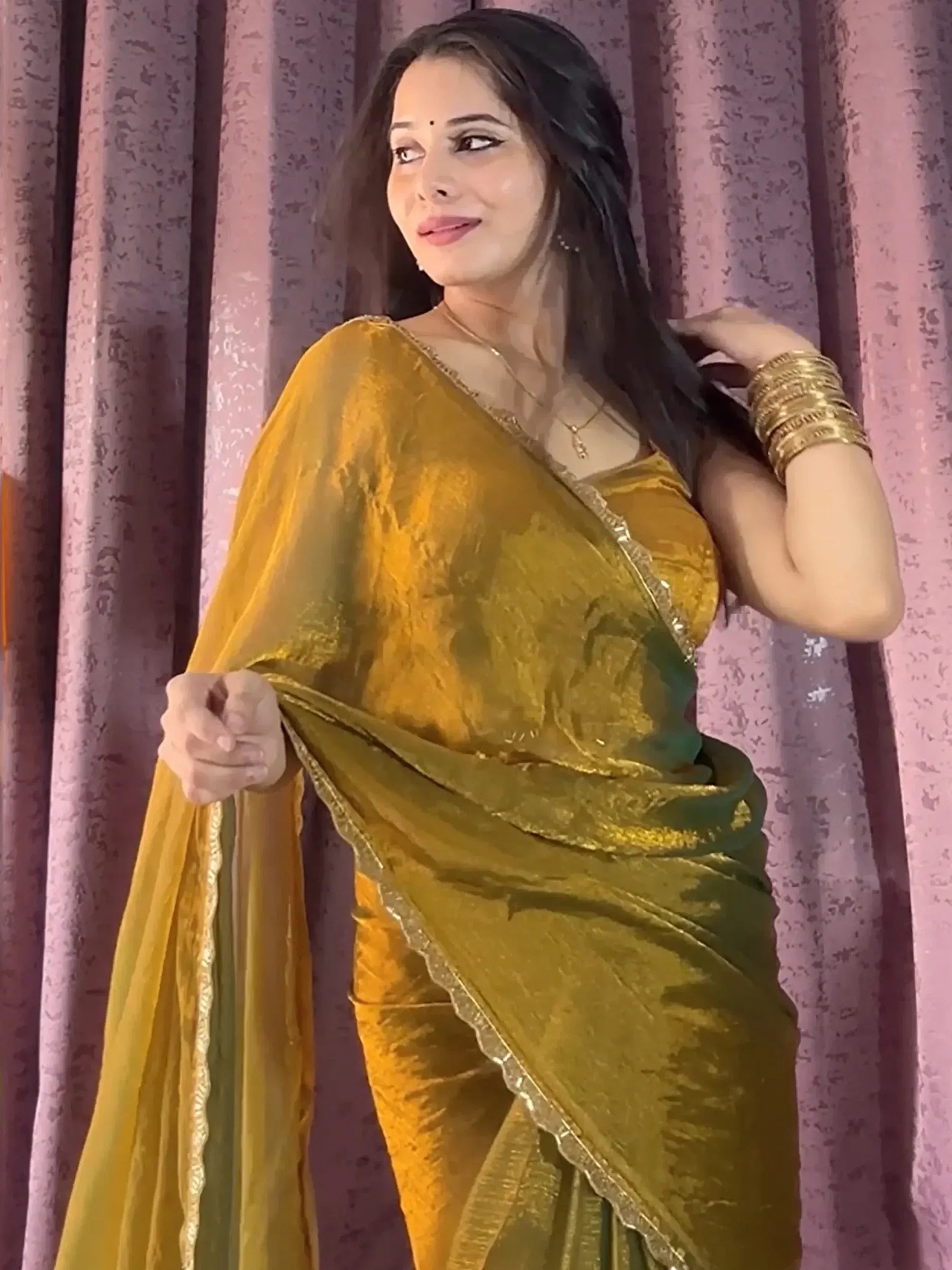 Woman in golden yellow velvet saree with gold border, ethnic Indian wear