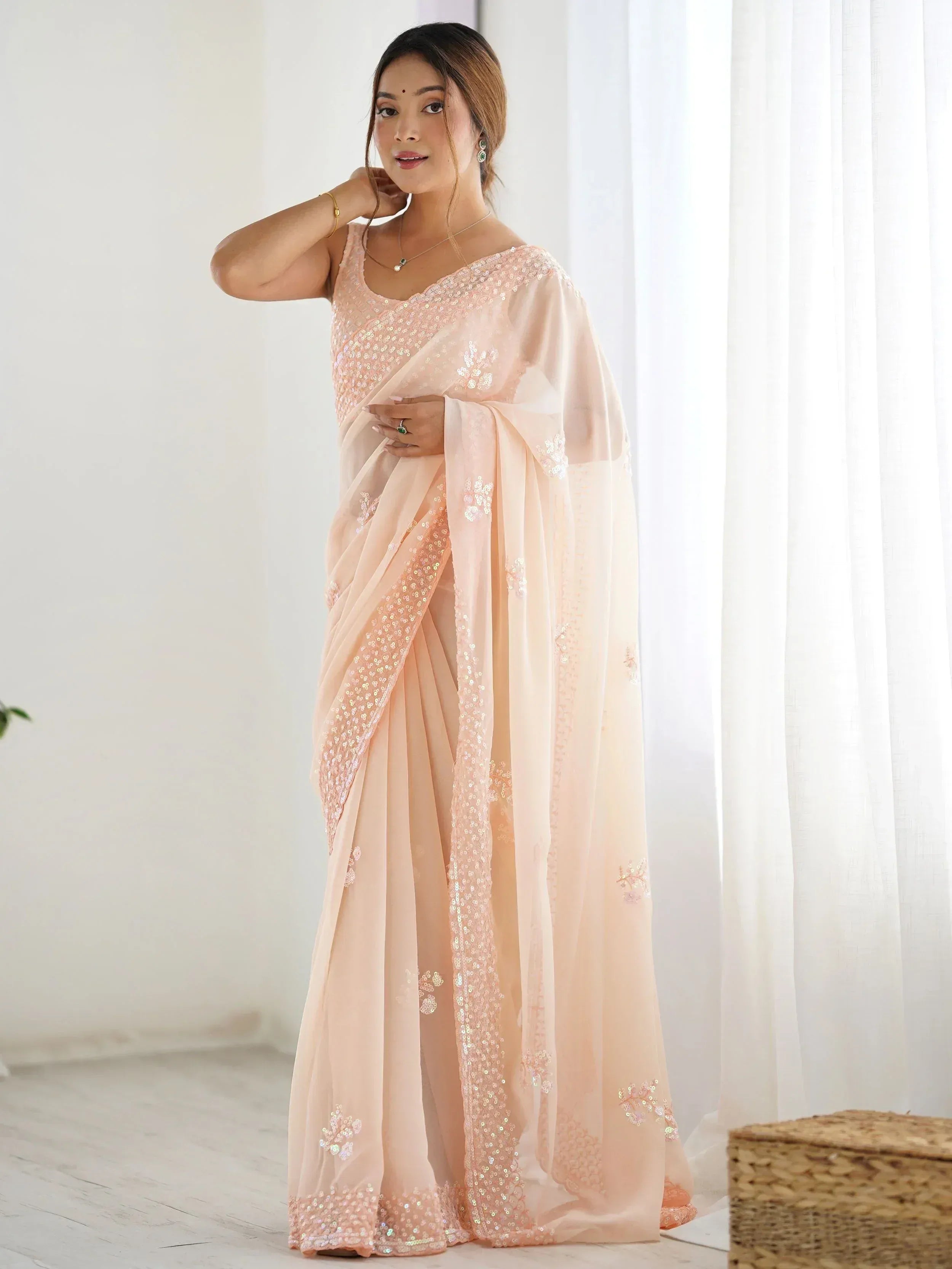 Elegant peach saree with sequin embroidery, perfect for Indian ethnic wear occasions