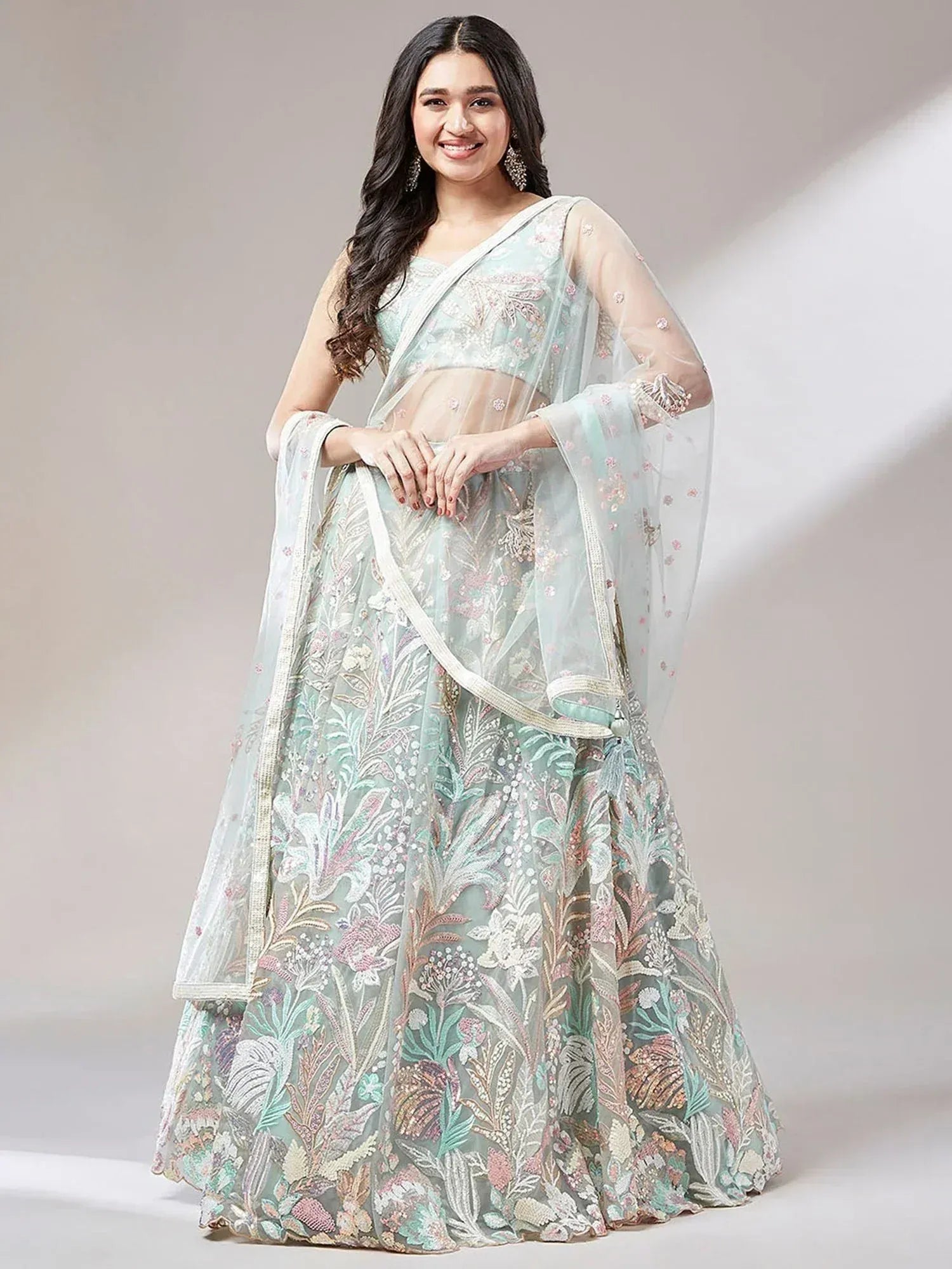 Mint green embroidered lehenga choli with floral motifs and sheer dupatta, perfect for Indian weddings and festivals.