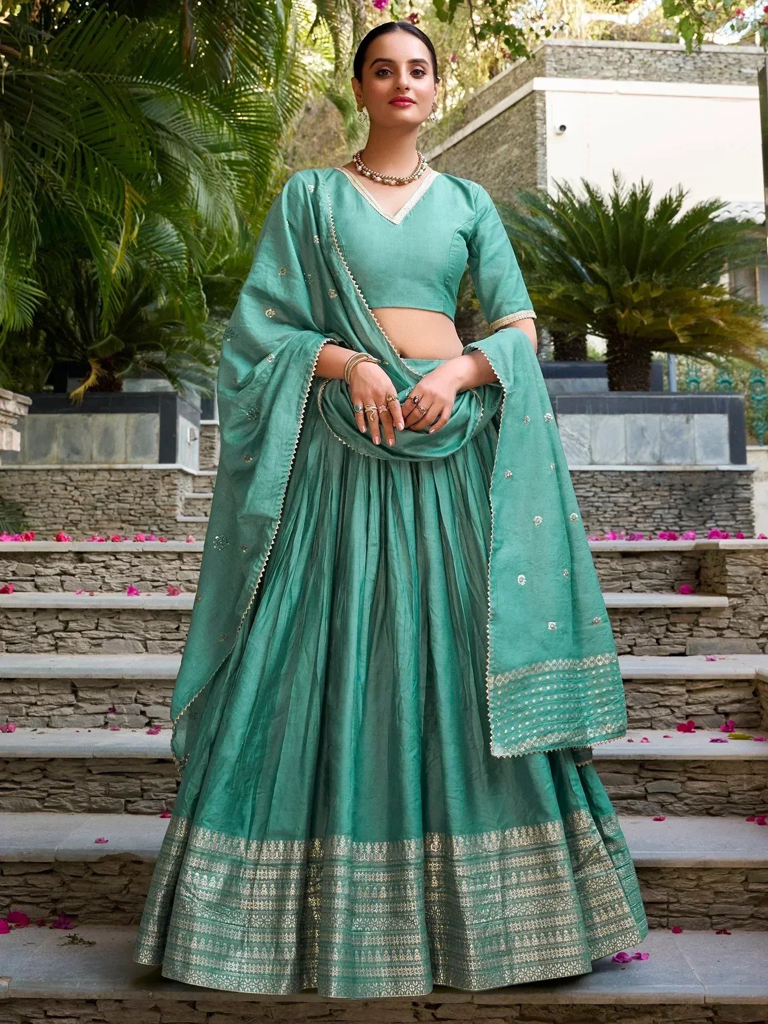 Teal green designer lehenga choli with gold embroidery, perfect for Indian ethnic wear and festive occasions.