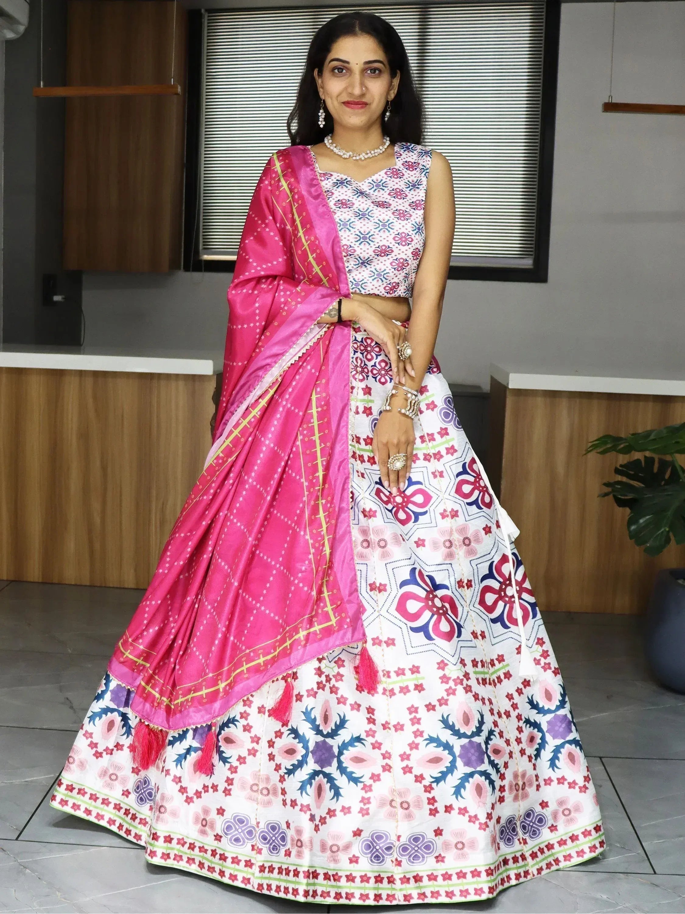 Woman in colorful floral lehenga choli with pink dupatta, Indian ethnic wear for festive occasions