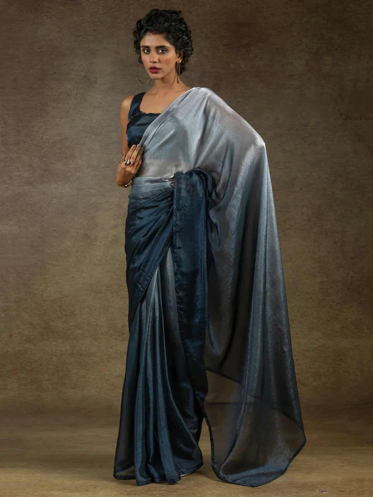 Woman in elegant navy blue silk saree with shimmering pallu, perfect for Indian ethnic occasions