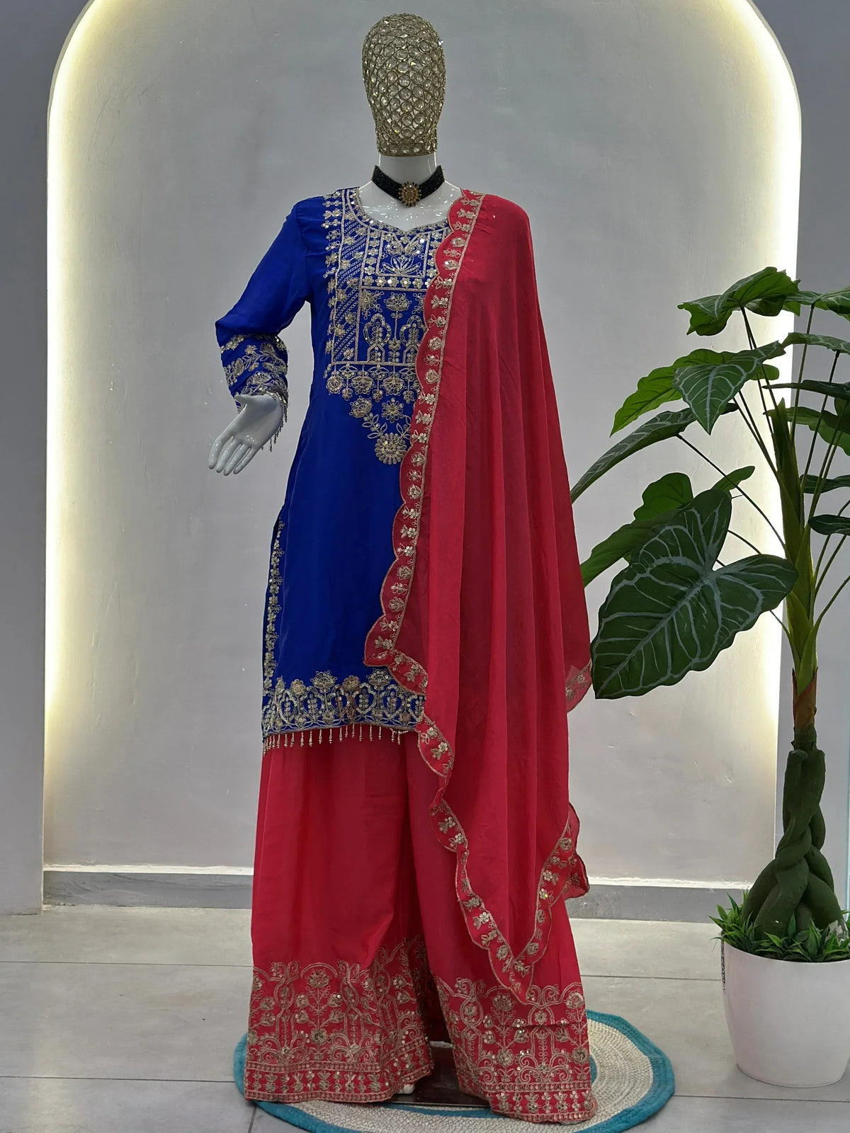 Blue and red embroidered salwar kameez with gold detailing, perfect for Indian ethnic wear occasions.